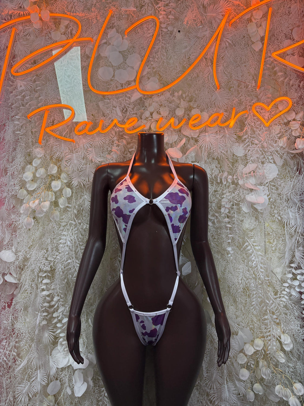 Purple cow-print one-piece dance bodysuit with halter neckline and cheeky cut