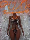 Leopard print one-piece dance bodysuit with black tie front and chain accents