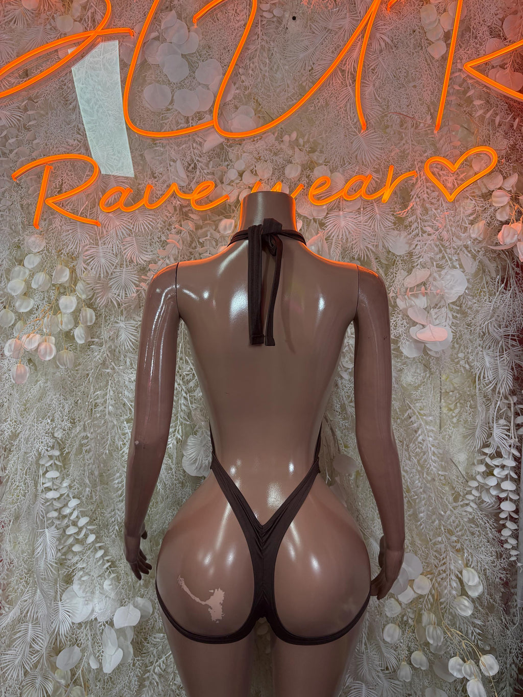 Brown high-cut halter bodysuit with V-neck and back tie
