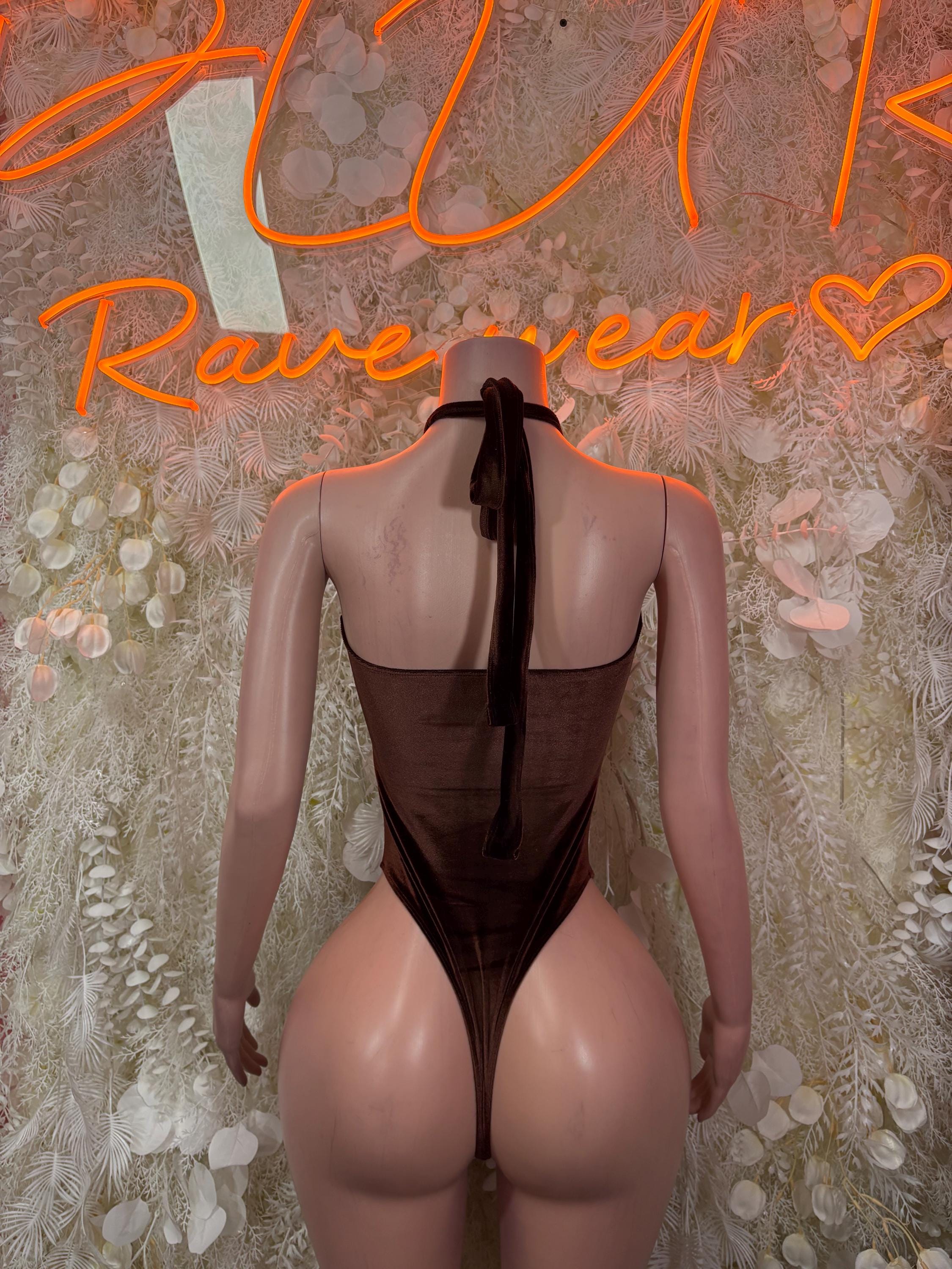 Dark bodysuit with halter tie at neck and deep open back, high-cut one-piece