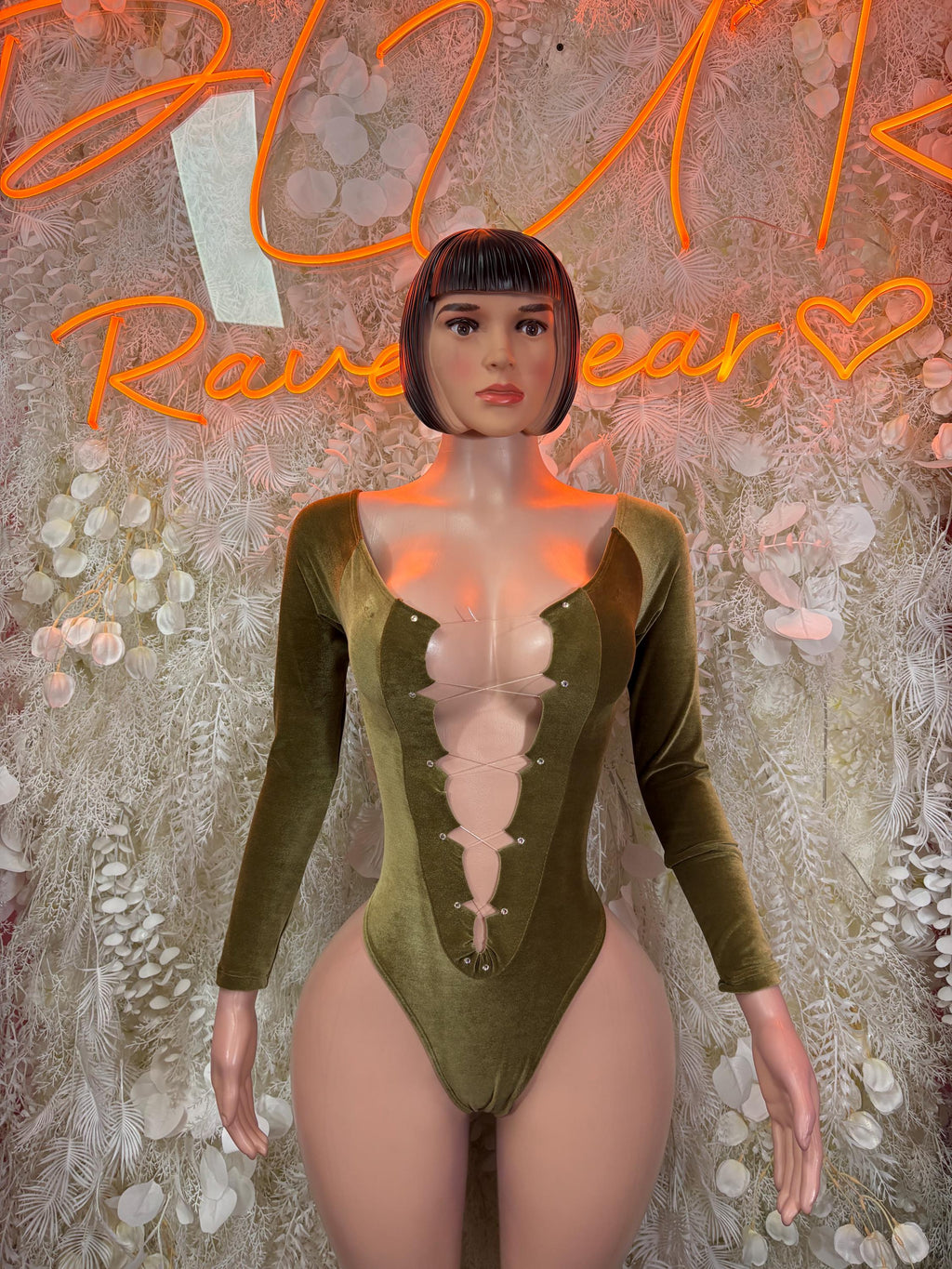 Velvet green long-sleeve bodysuit with deep V neckline, fitted velvet stretch.
