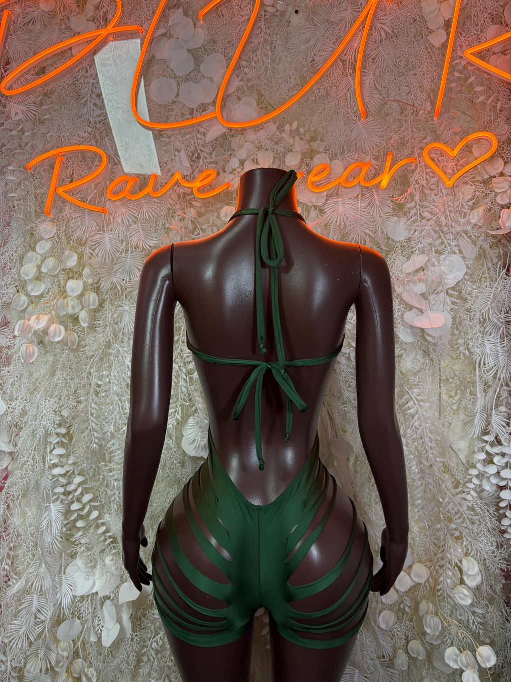 Green backless rave bodysuit with tie closure and striped lower back cutouts
