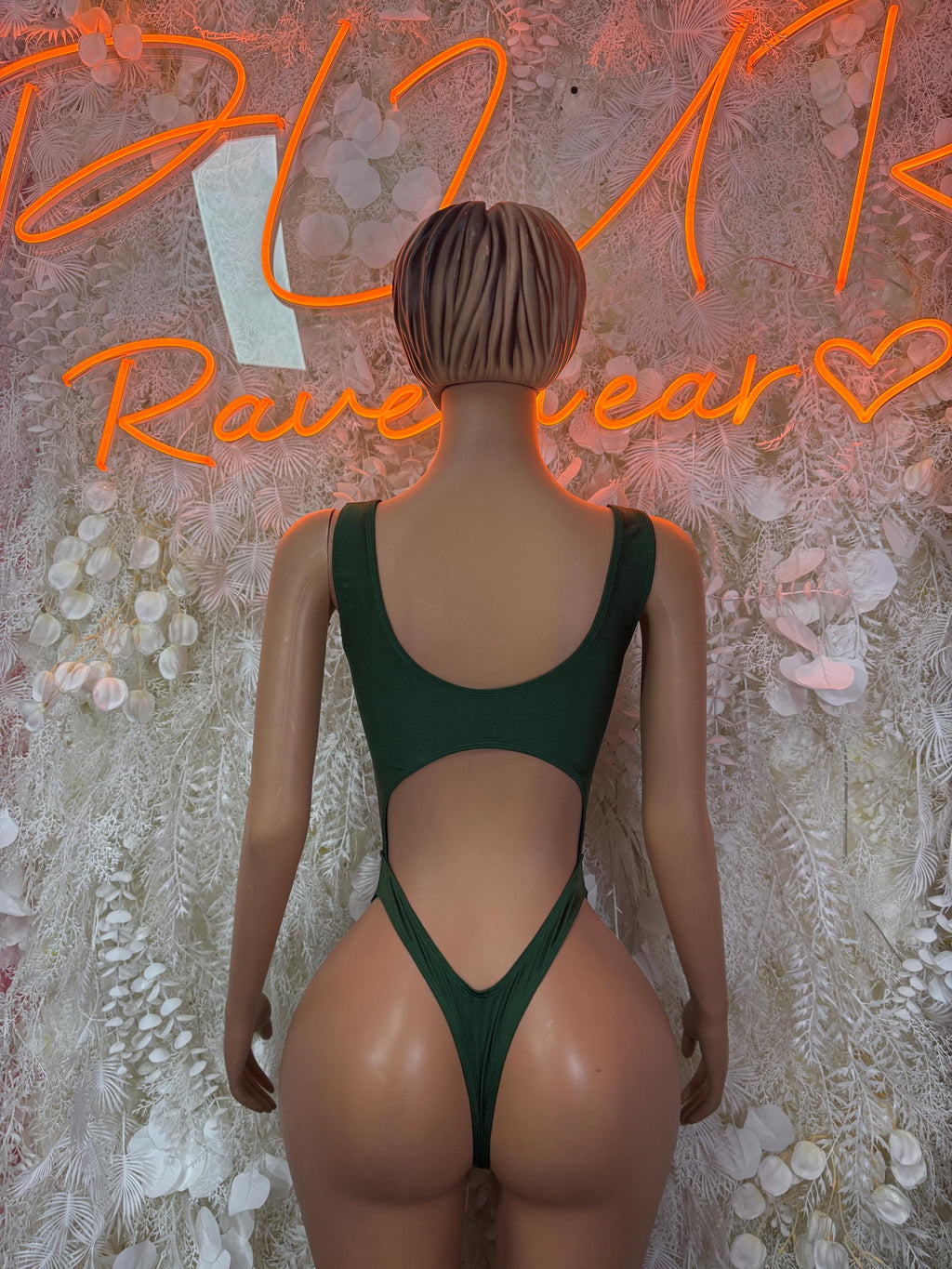 Green one-piece festival bodysuit with open back and V-shaped waist cut