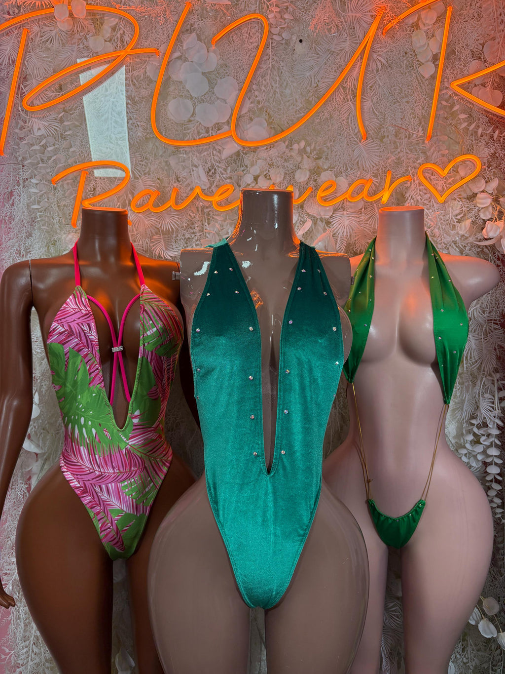 Green velvet one-piece bodysuit with deep V front and open back, halter straps