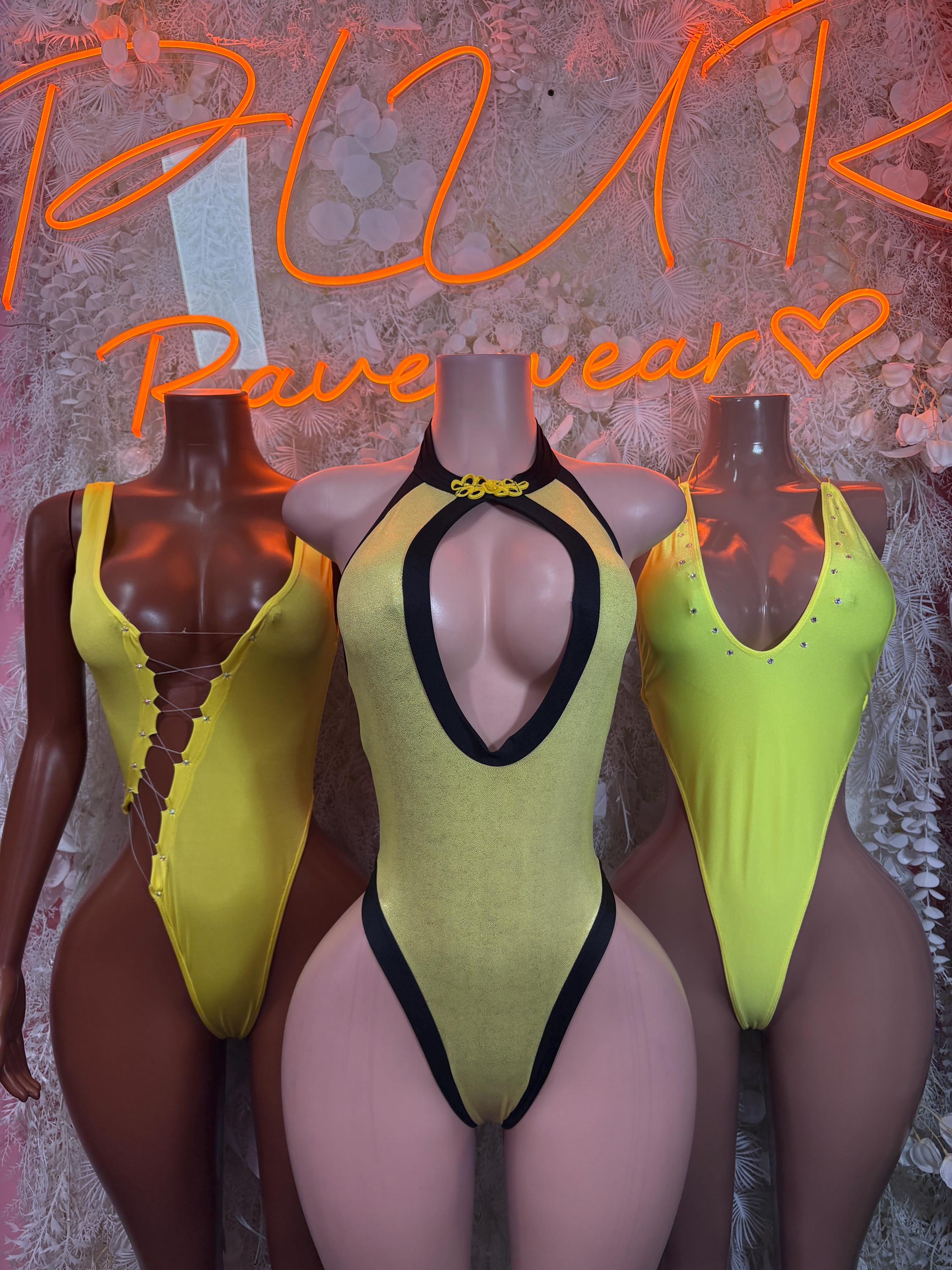 Set of three yellow metallic bodysuits with black trim and keyhole neckline