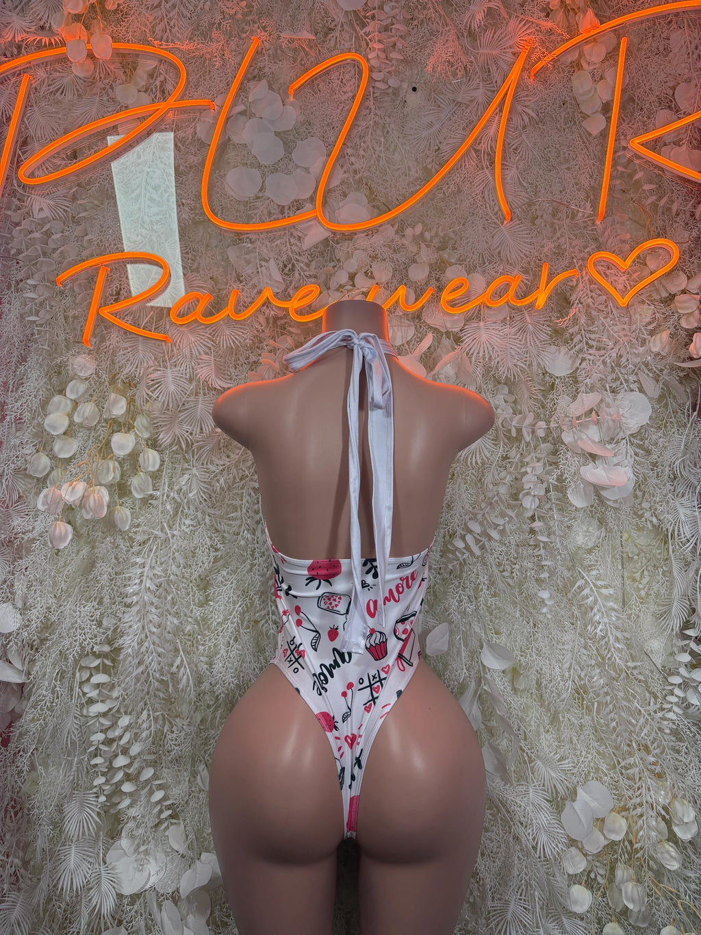 One-piece swimsuit with white heart-and-text print, open back and halter tie