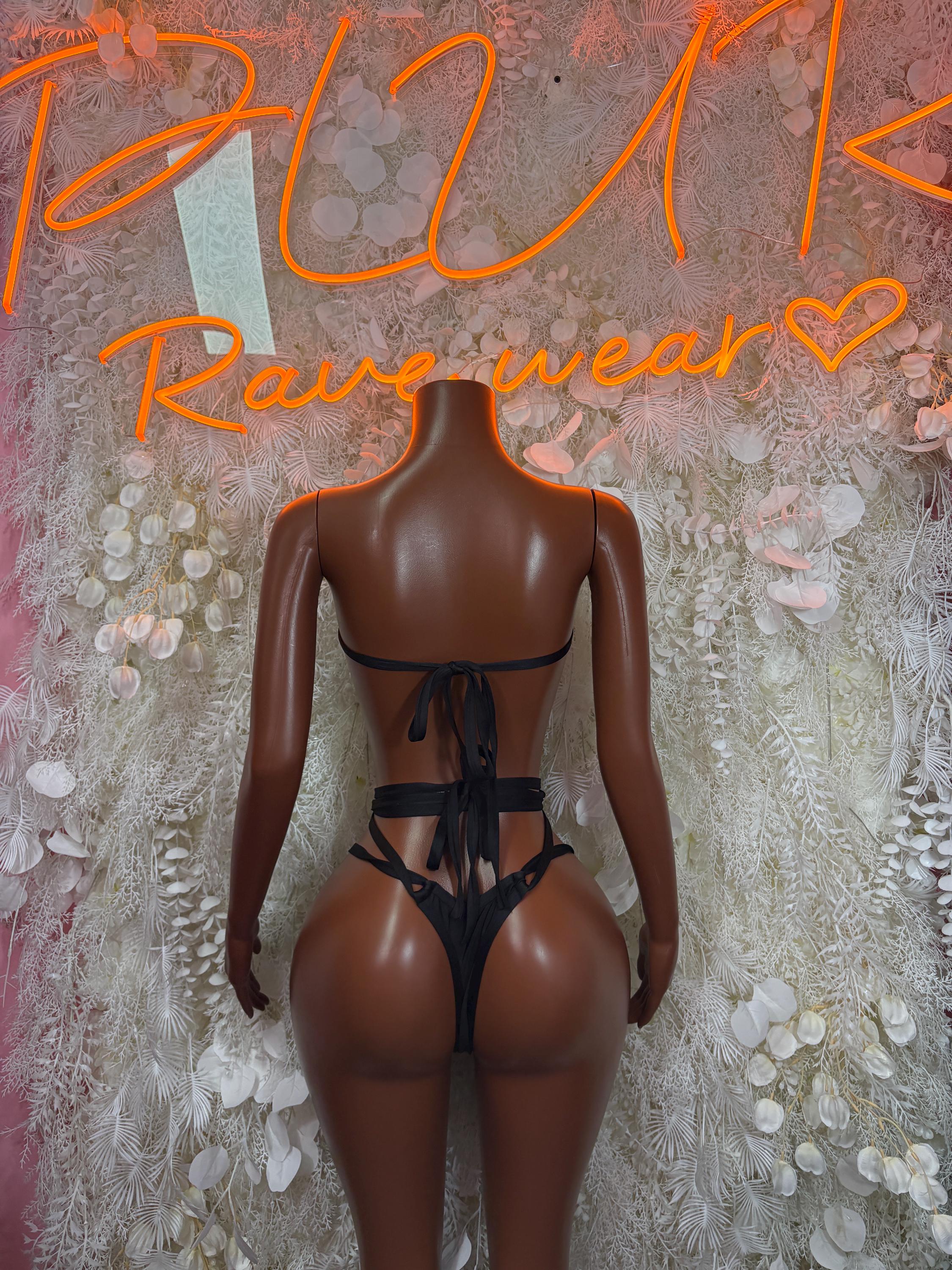 Black two-piece bodysuit with halter bandeau top and back-tie thong bottoms, chain accents