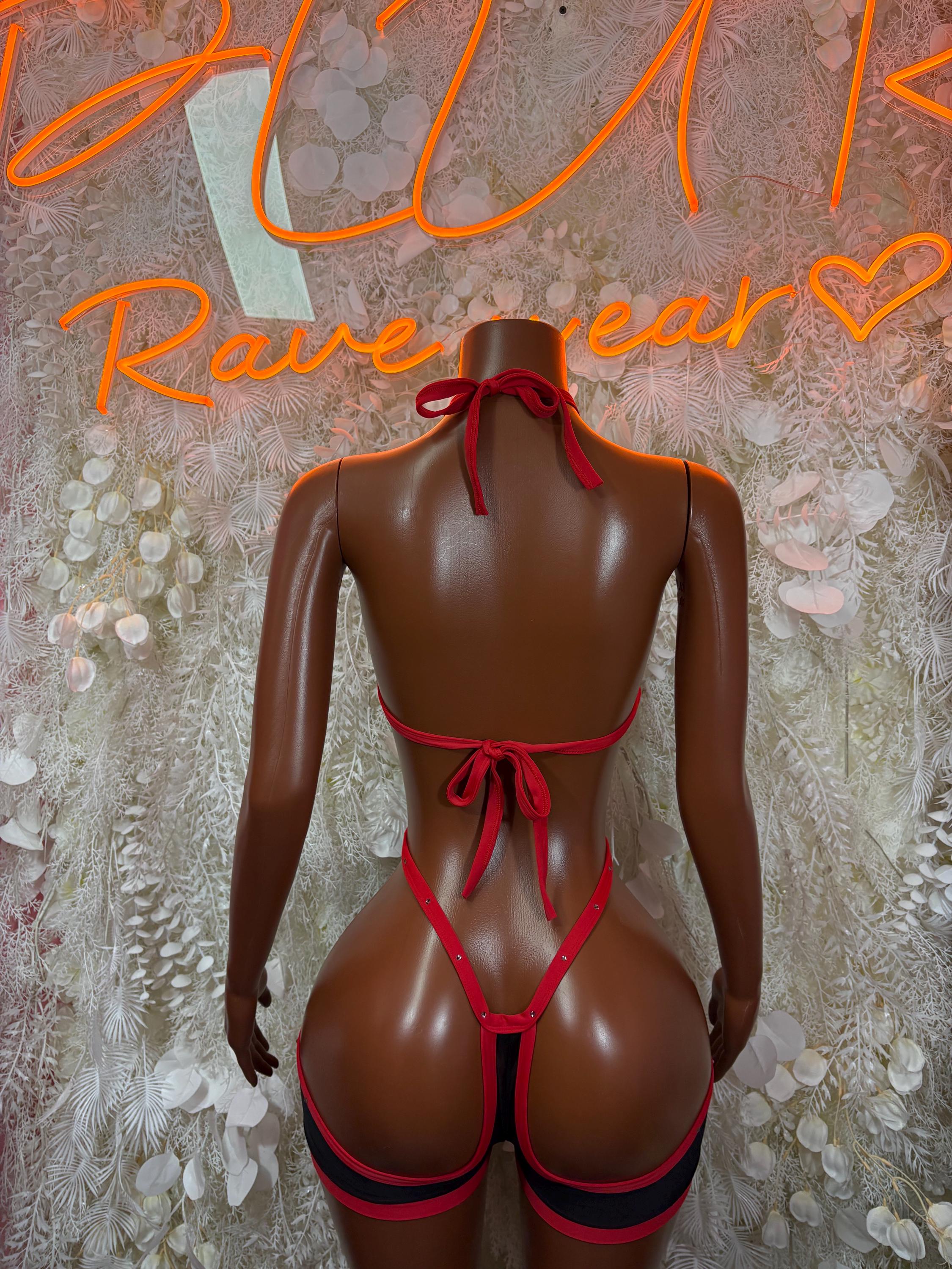 Red-and-black backless harness bodysuit with tie straps and bow