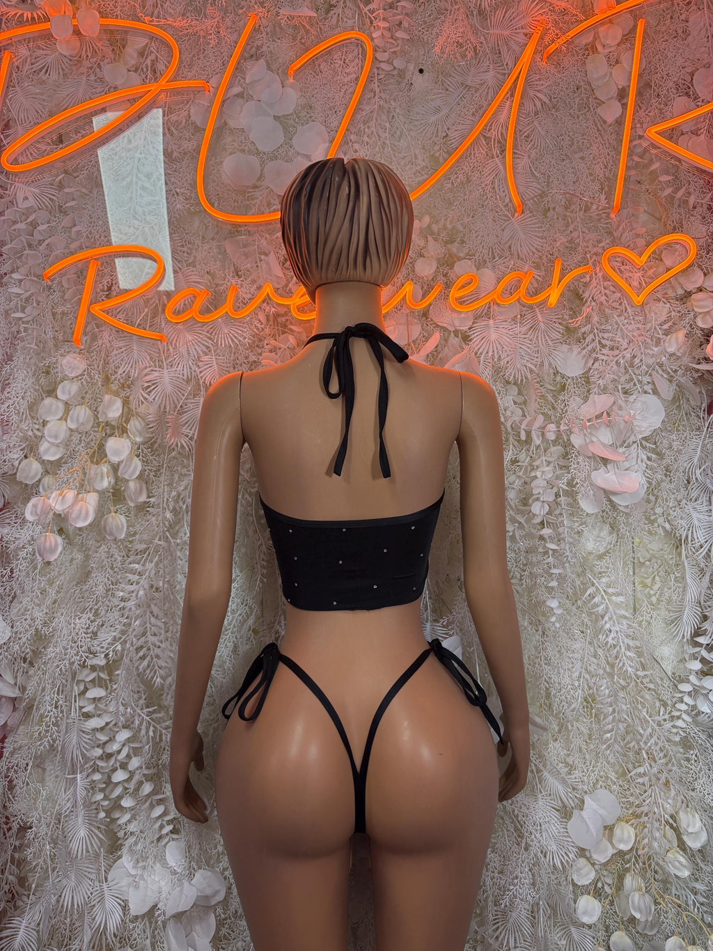 Black backless halter crop top with crisscross straps and tie-side bikini bottoms