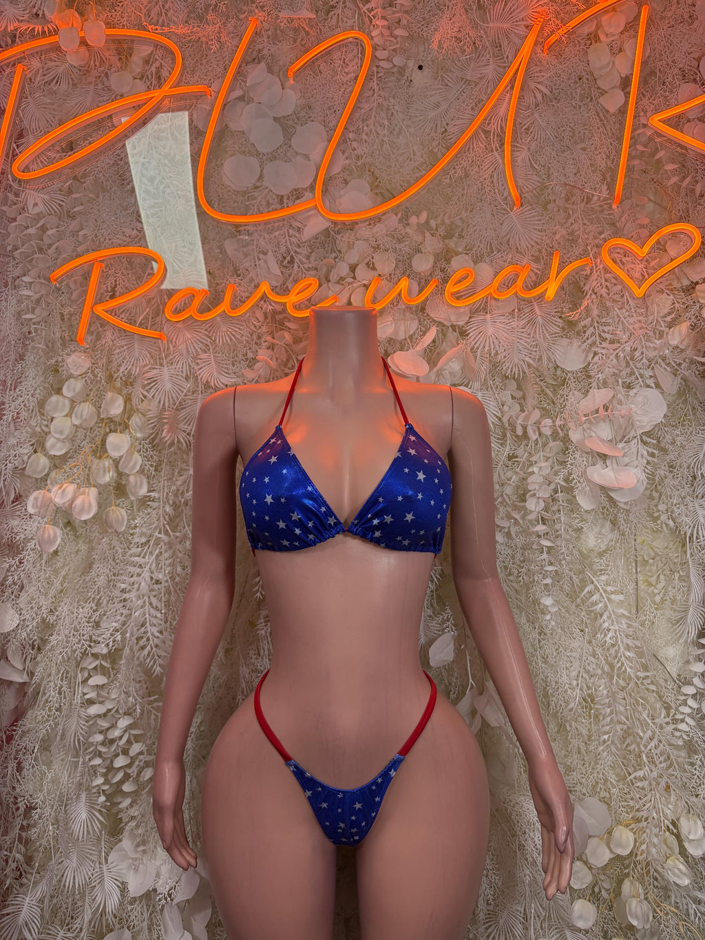 Star-print blue triangle bikini with red trim, front view