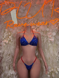 Star-print blue triangle bikini with red trim, front view