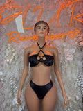 Black two-piece bikini set with ring-tied halter top and high-cut bottoms