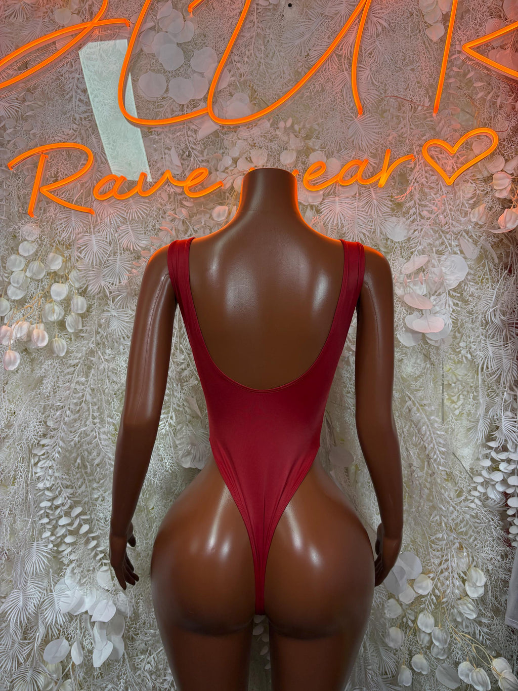 Red backless bodysuit with wide straps and centered back opening