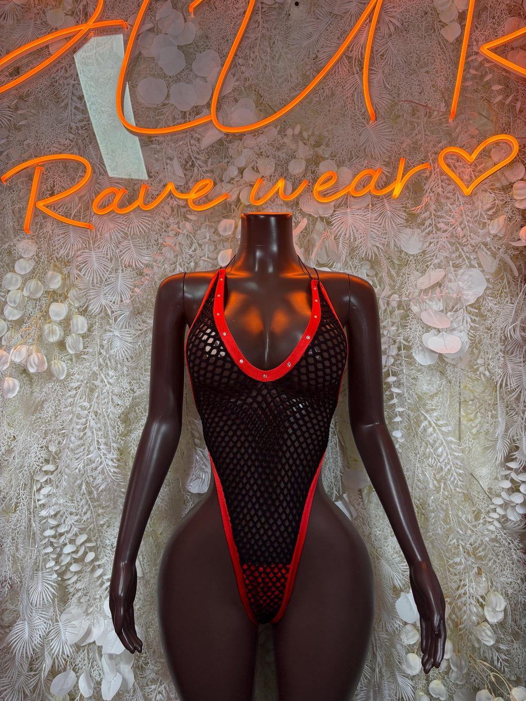 Black fishnet bodysuit with red trim, low-cut one-piece dance outfit