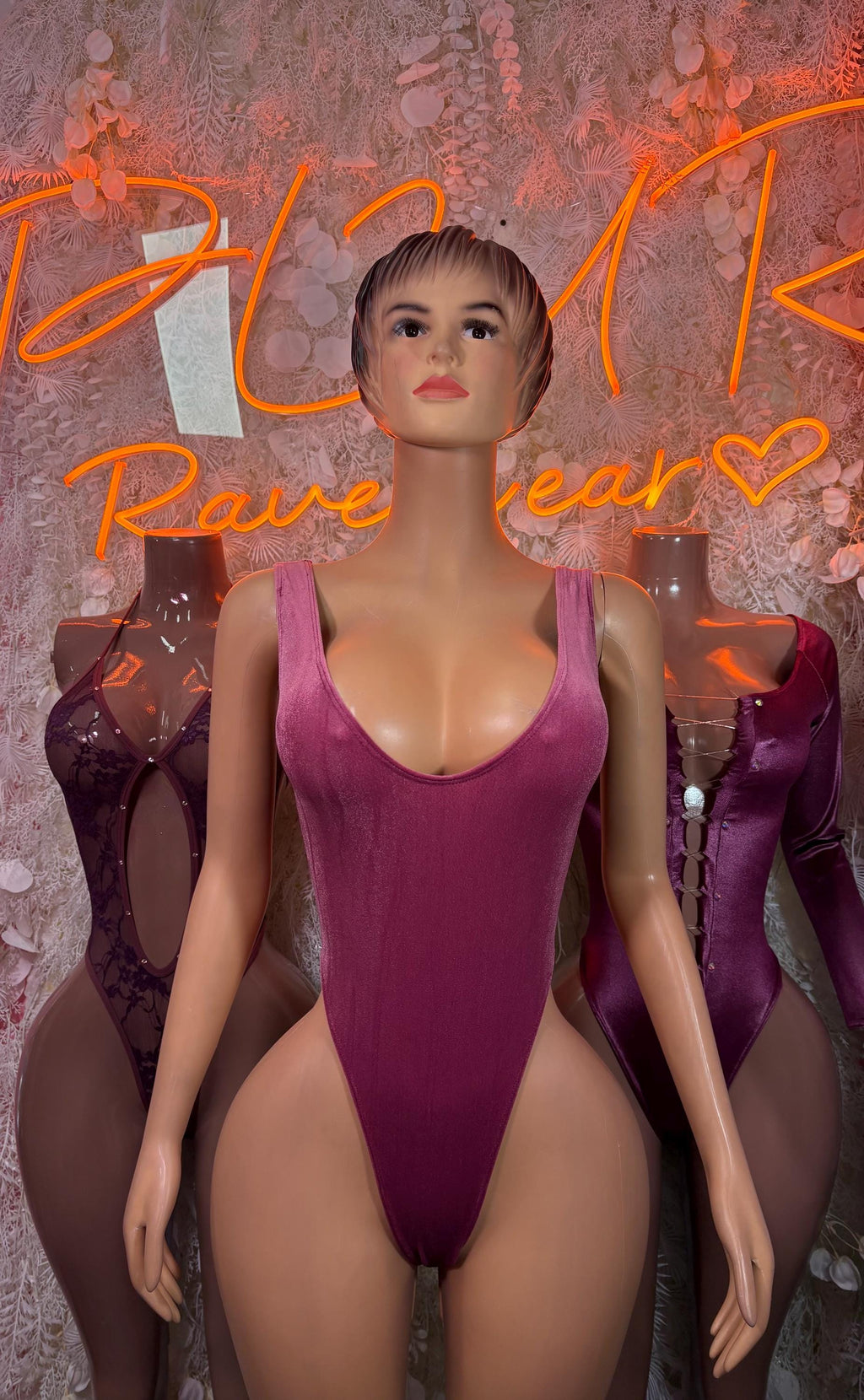 Purple sleeveless lace bodysuit with deep V neckline and sheer lace inserts