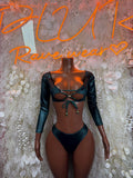 Green two-piece rave set: long-sleeve cropped top with lace-up front and high-cut bottoms