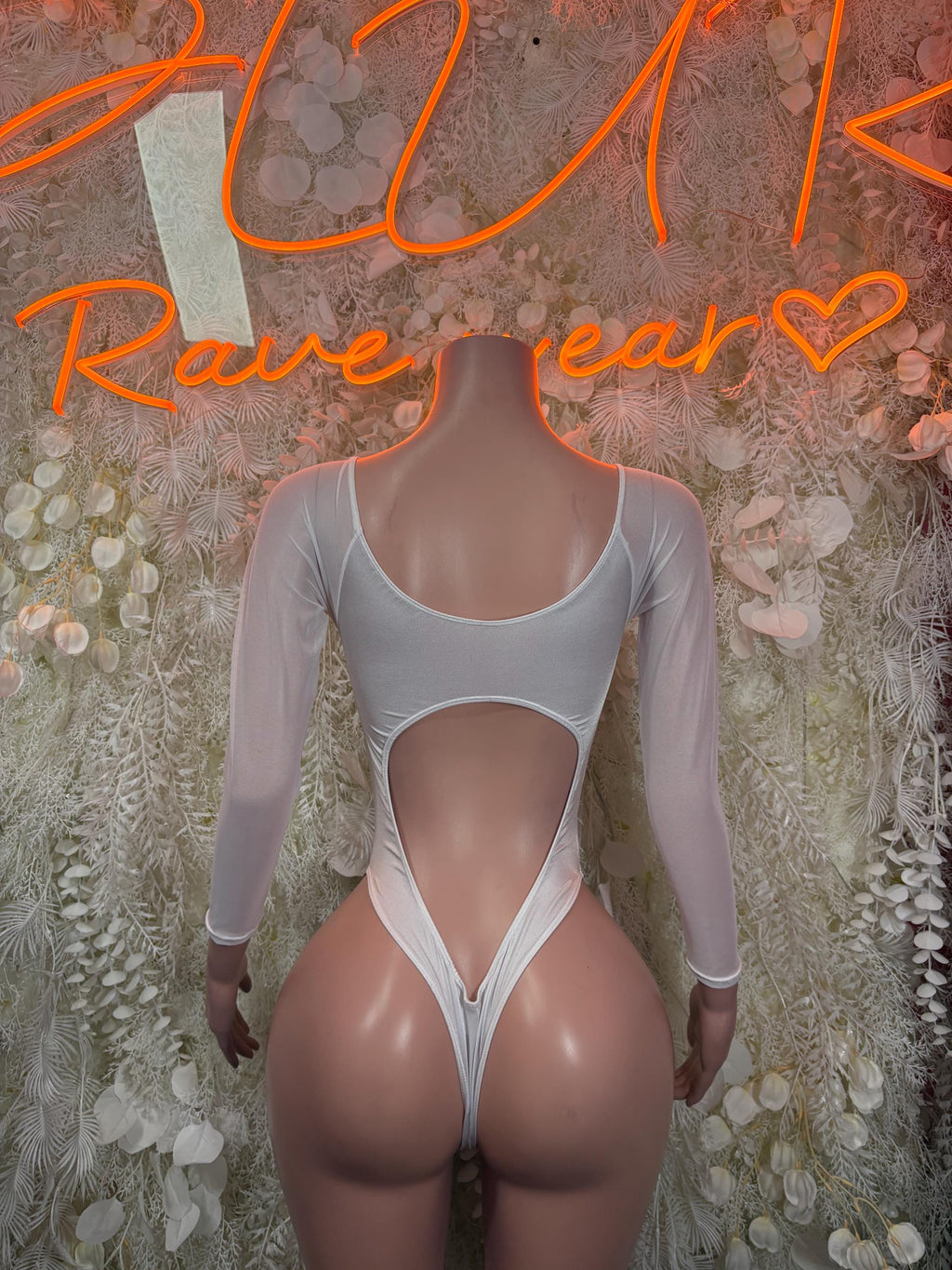 White long-sleeve bodysuit with scoop neckline and high-leg thong-style bottom