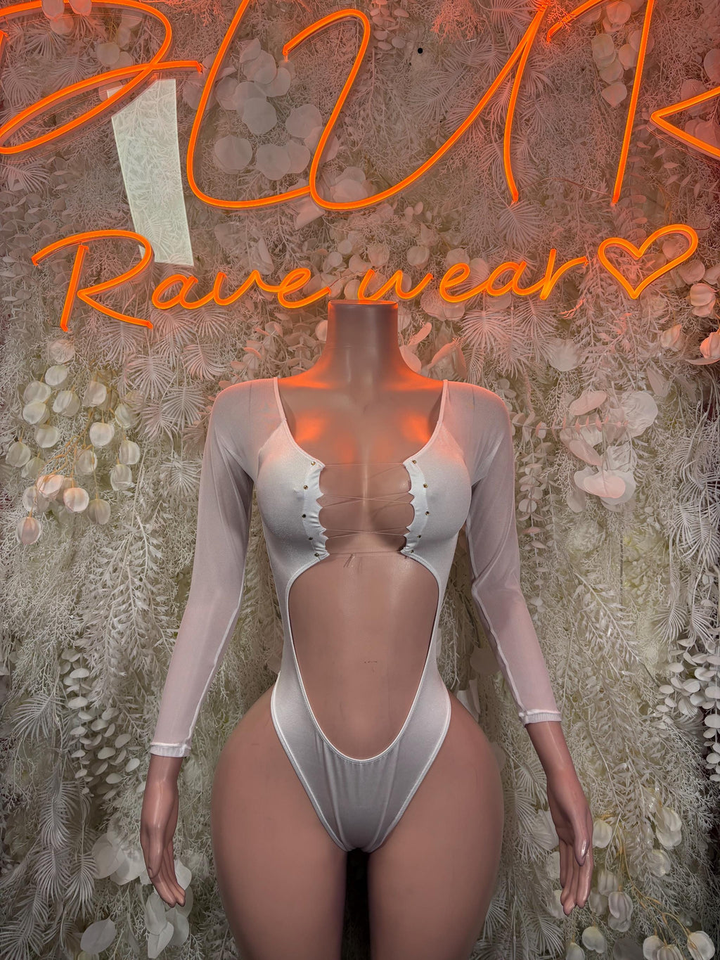White long-sleeve bodysuit, sweetheart neckline, snap front, thong-style bottom