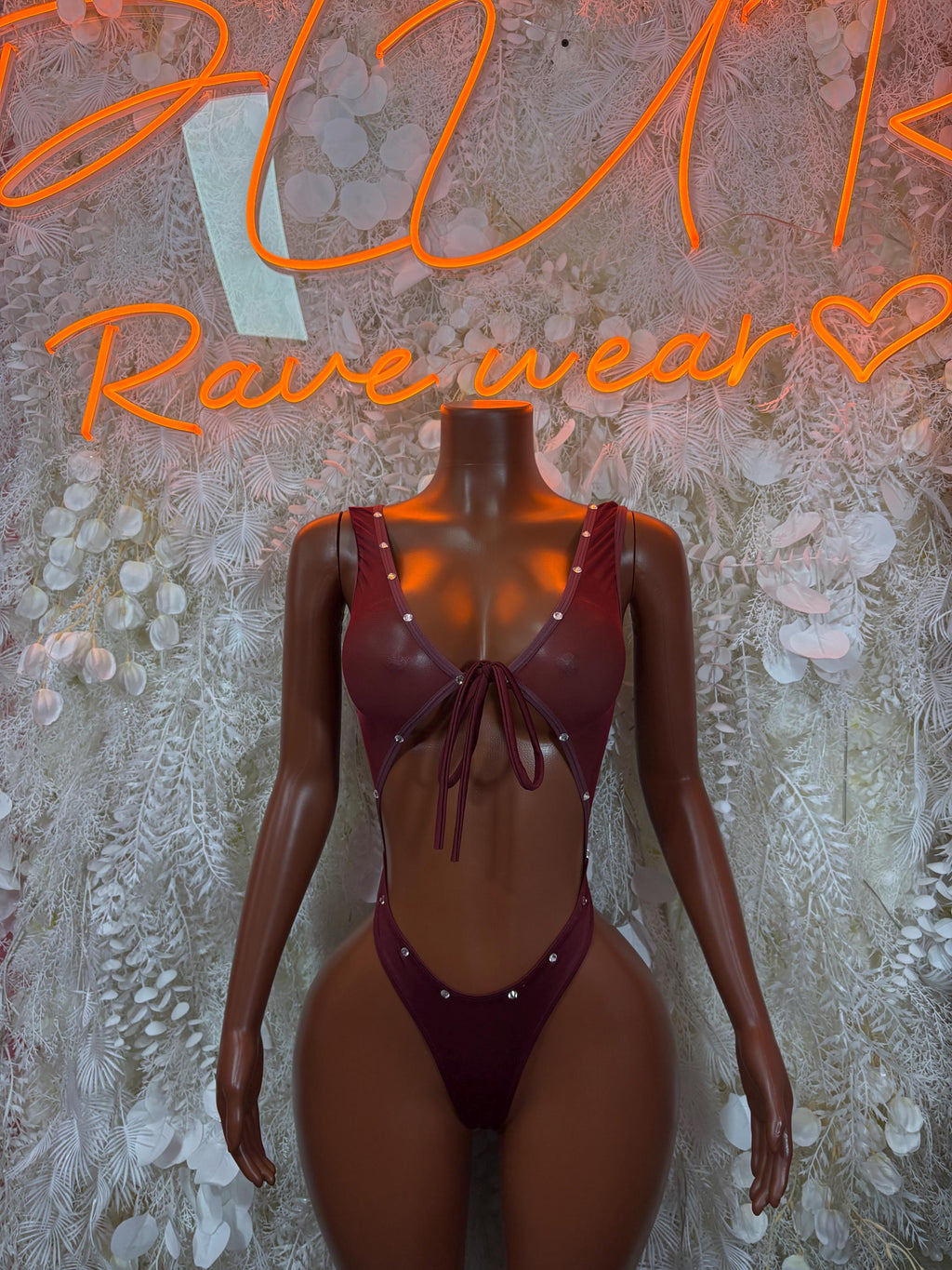 Burgundy sleeveless V-neck bodysuit with center tie and high-cut thong-style bottom