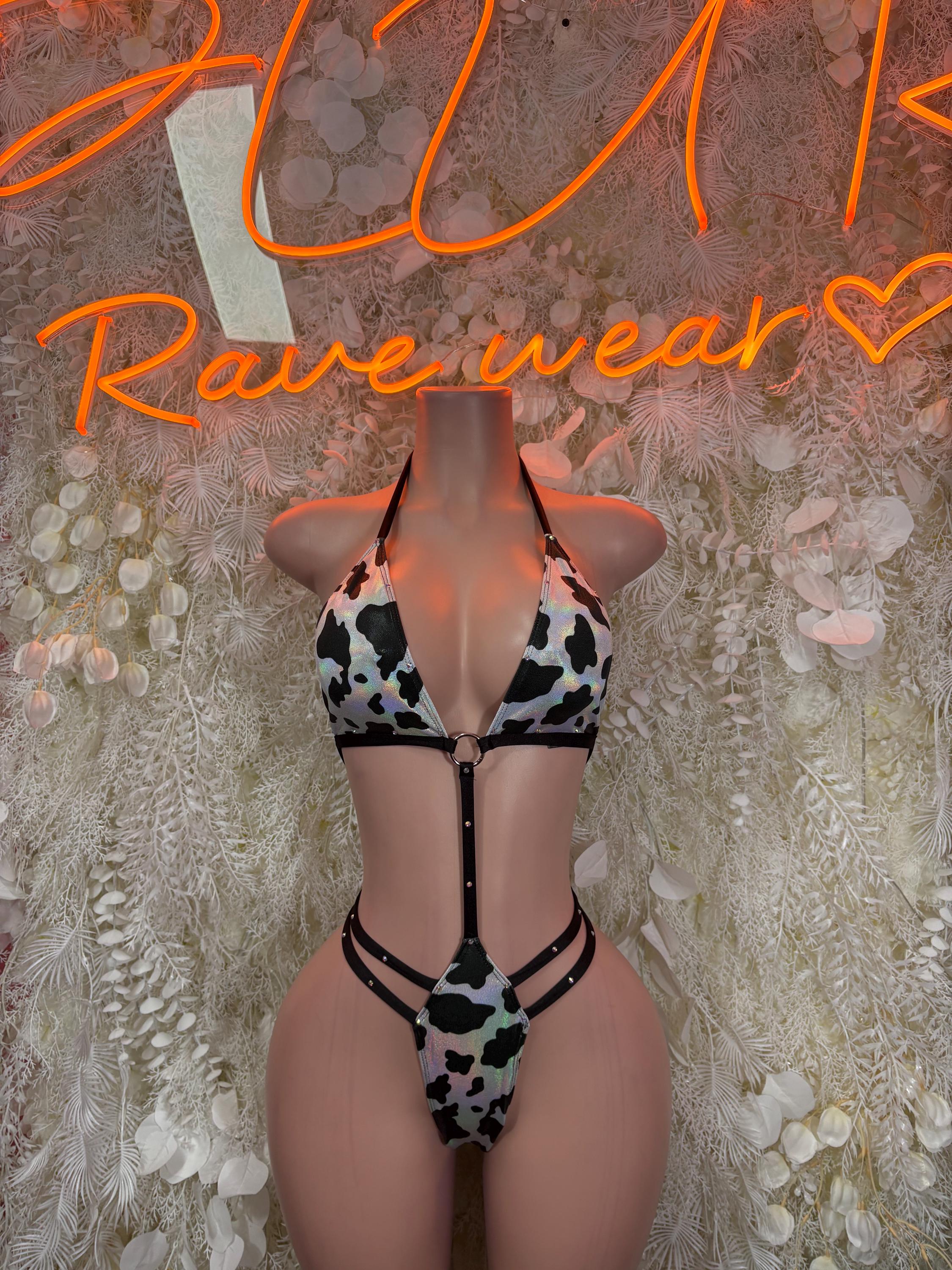 Black and white cow print bikini set with triangle top and high-cut bottoms, strappy ties