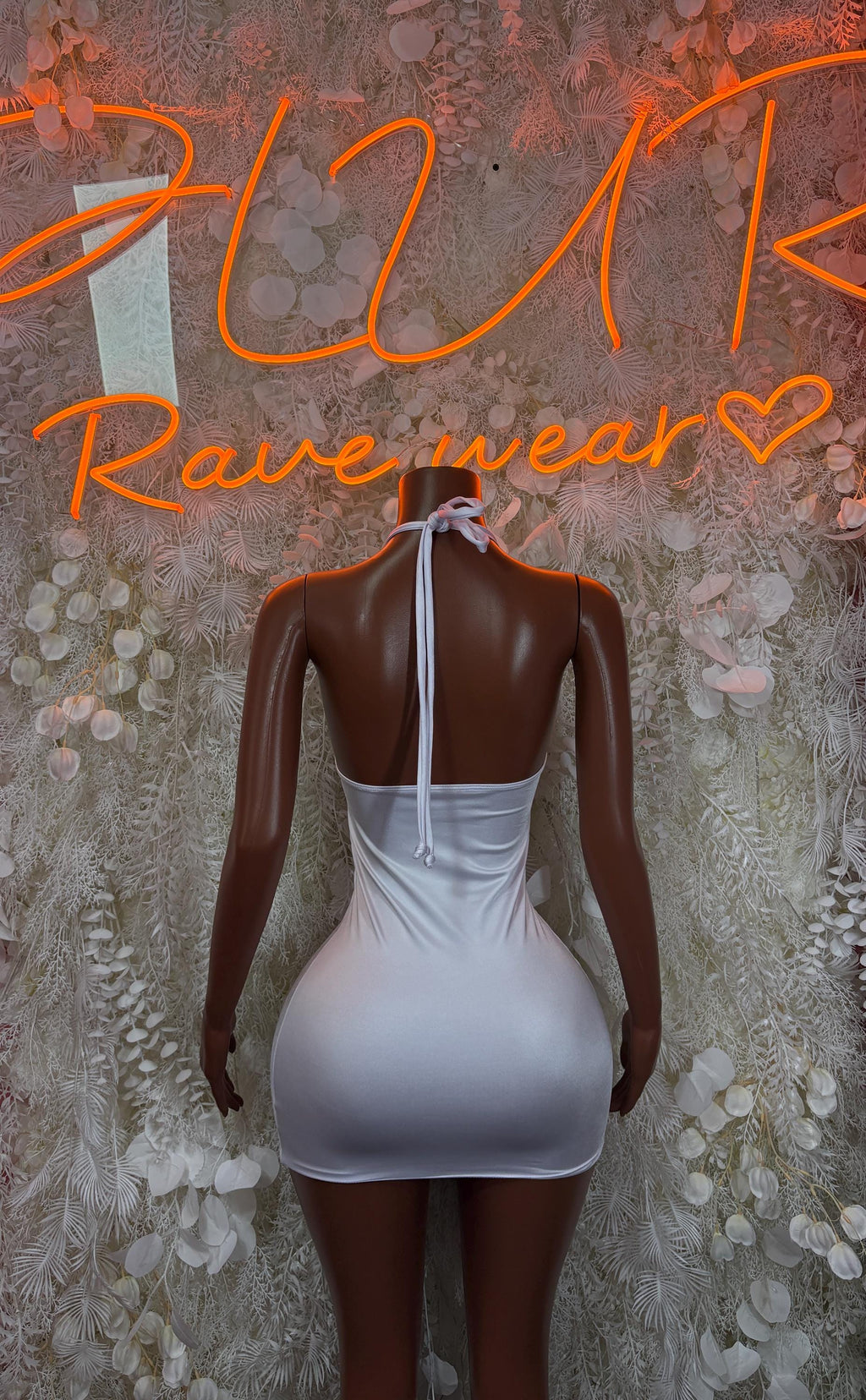White backless mini dress with strappy back and oval cutout detailing, sleeveless