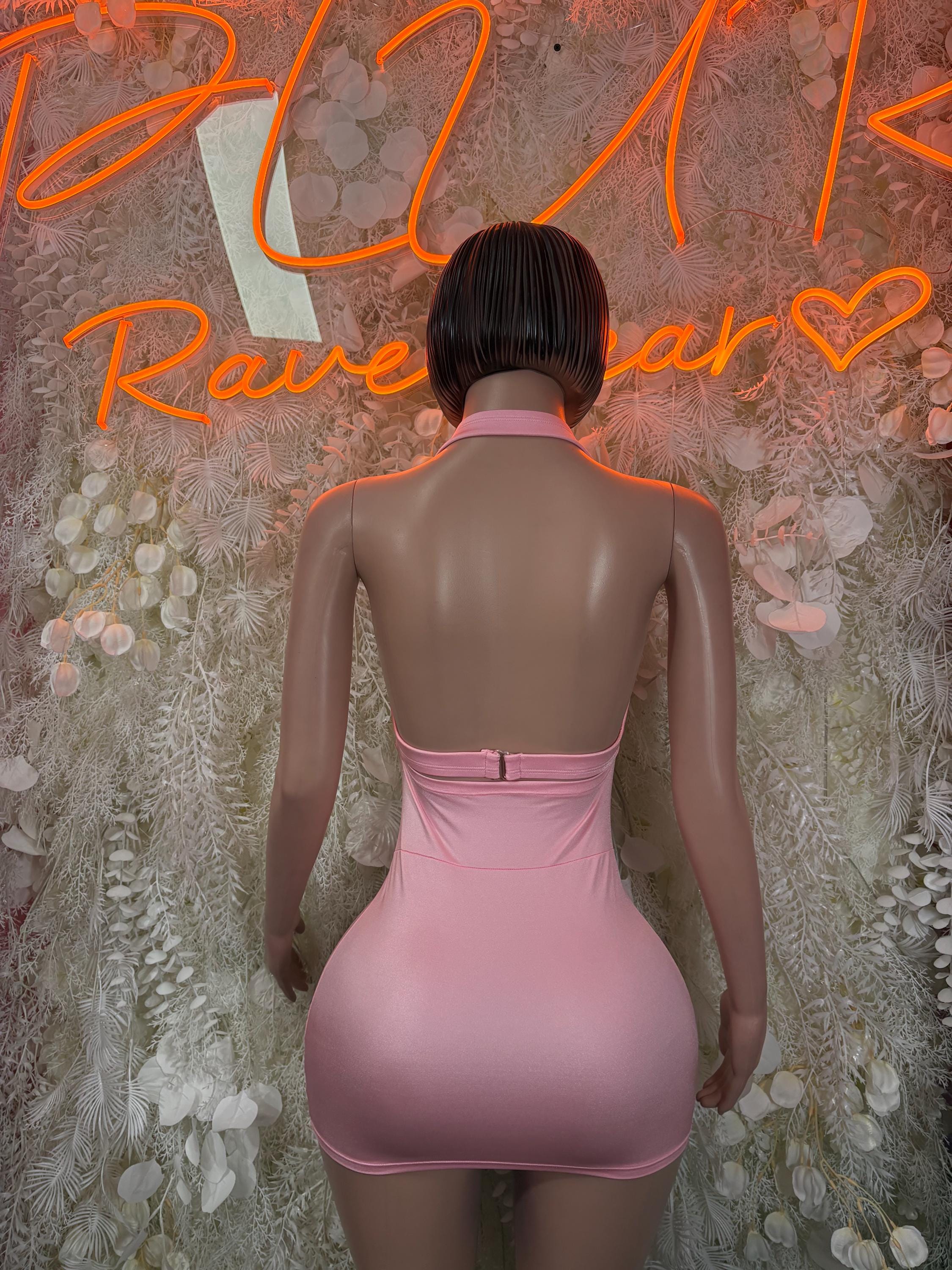Pink mini dress with open back on model, crossover strap detail
