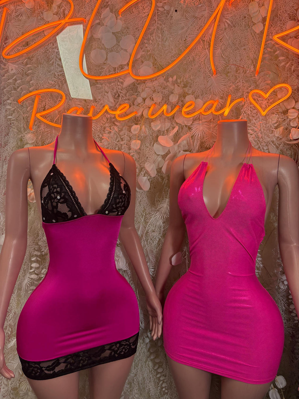 Neon pink mini bodycon dress with black lace trim and scoop neckline