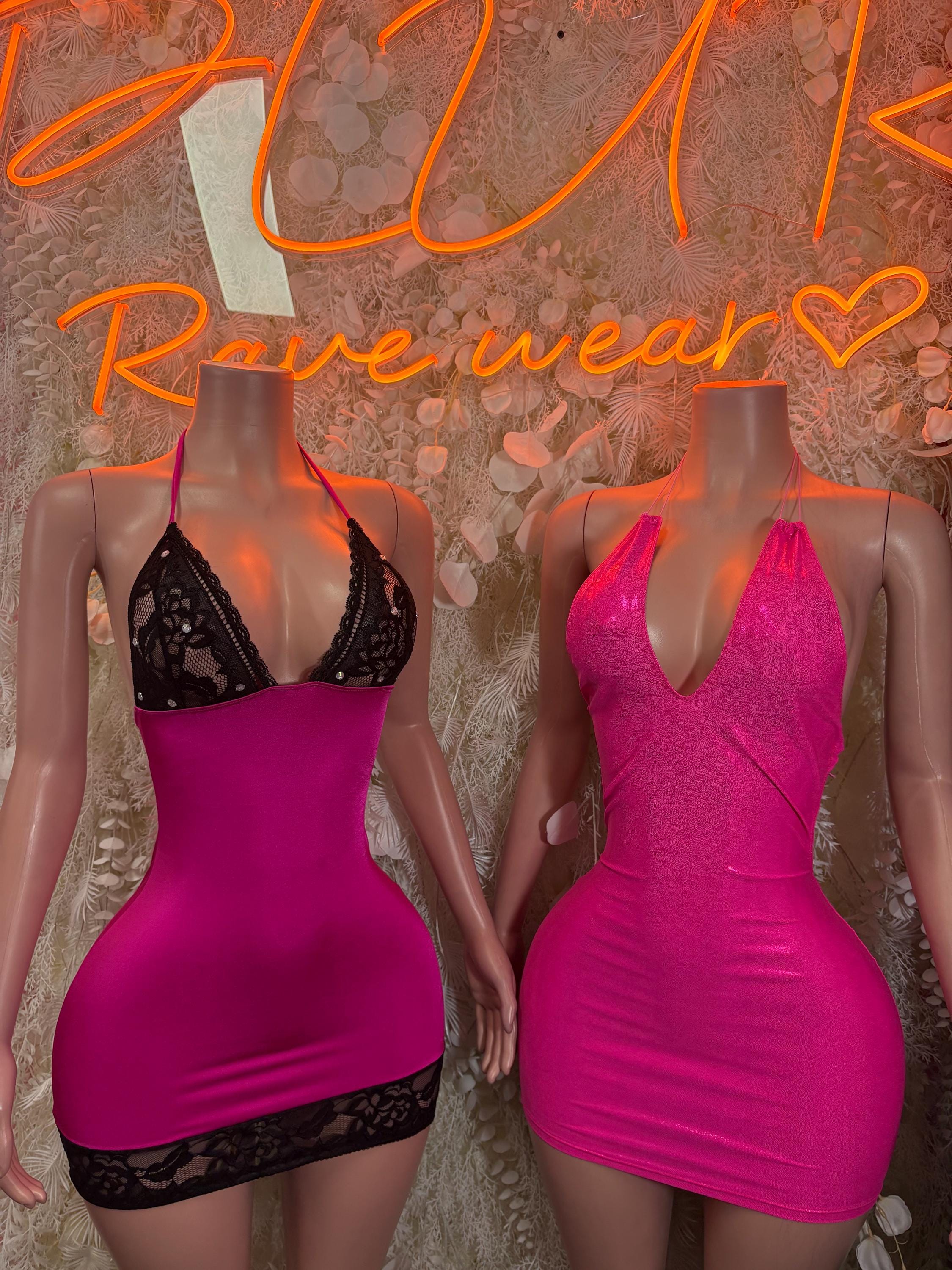 Neon pink mini bodycon dress with black lace trim and scoop neckline