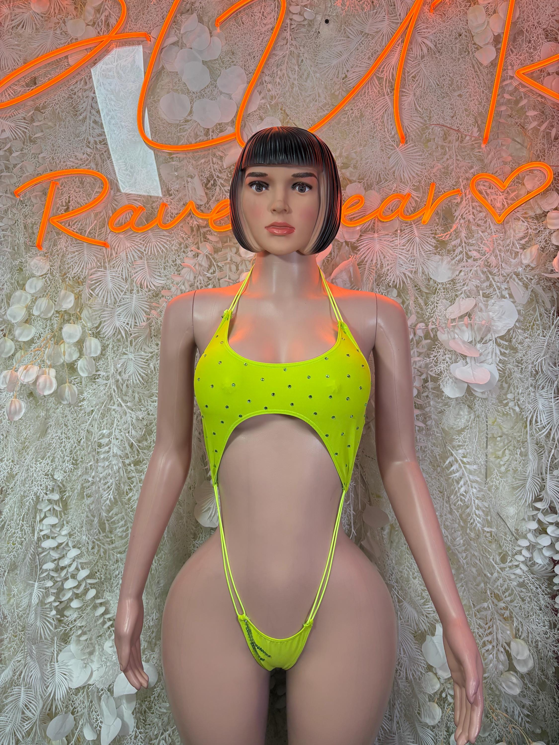 Neon green one-piece slingshot bodysuit with thin straps and front cutout