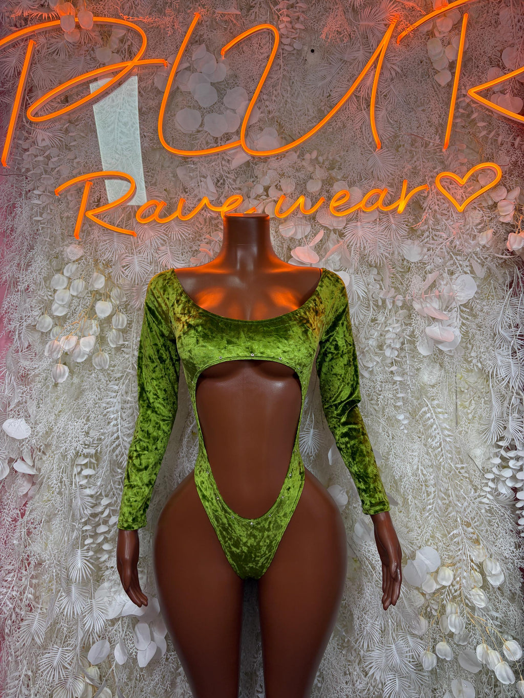 Green velvet bodysuit with long sleeves, scoop neck, and central cutout