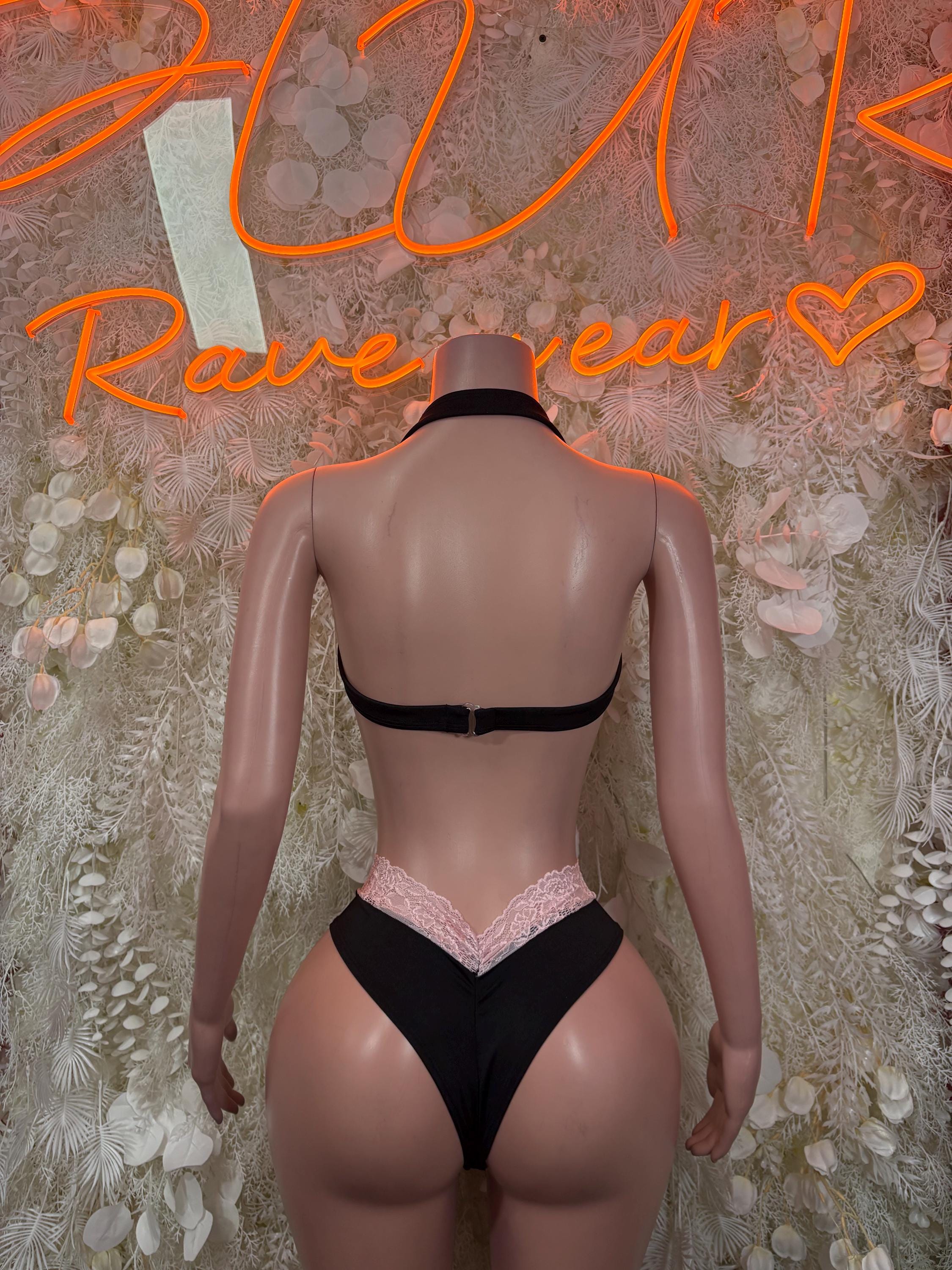 Two-piece lace festival set, back view: black bra with pink lace-trim bikini bottoms