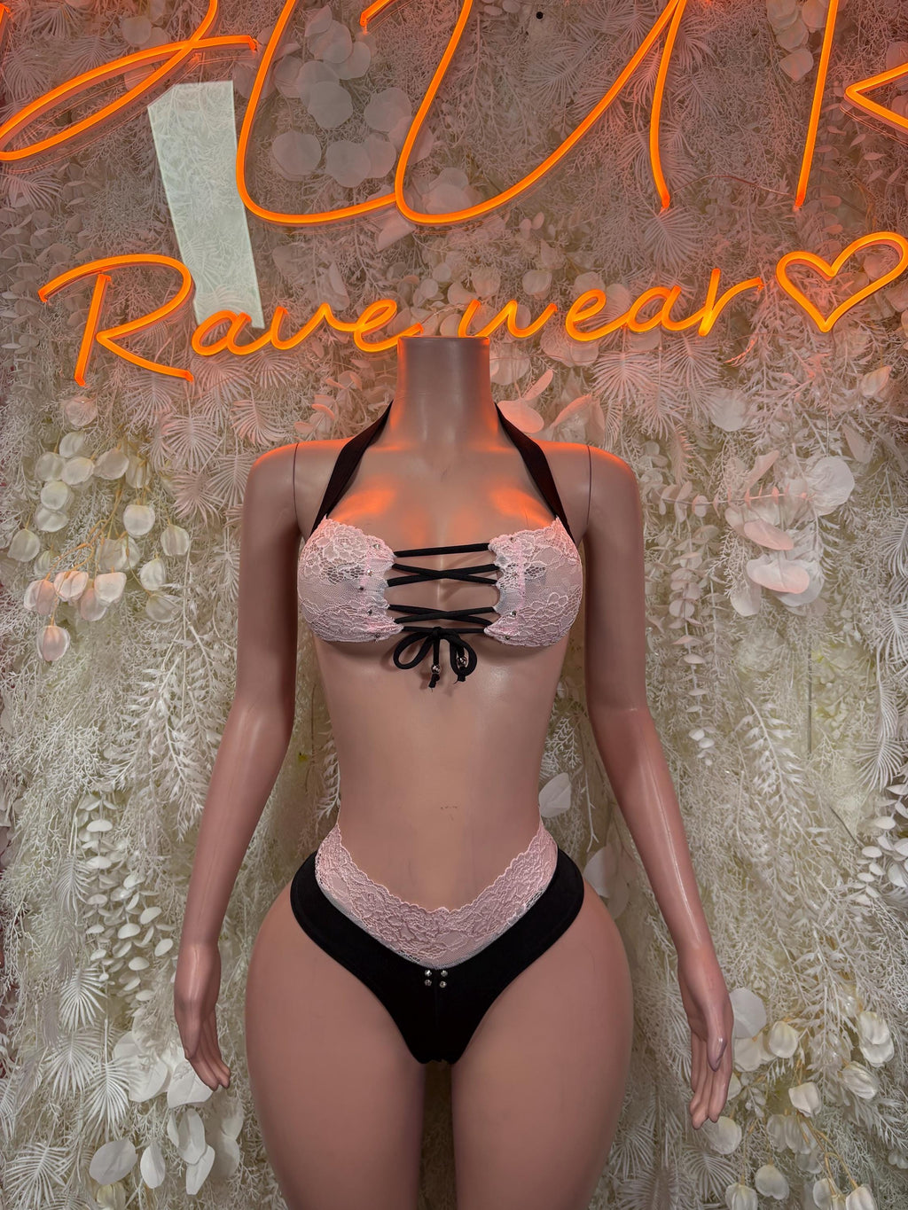 Two-piece lace festival set: pink lace bra with bow, black bikini bottoms