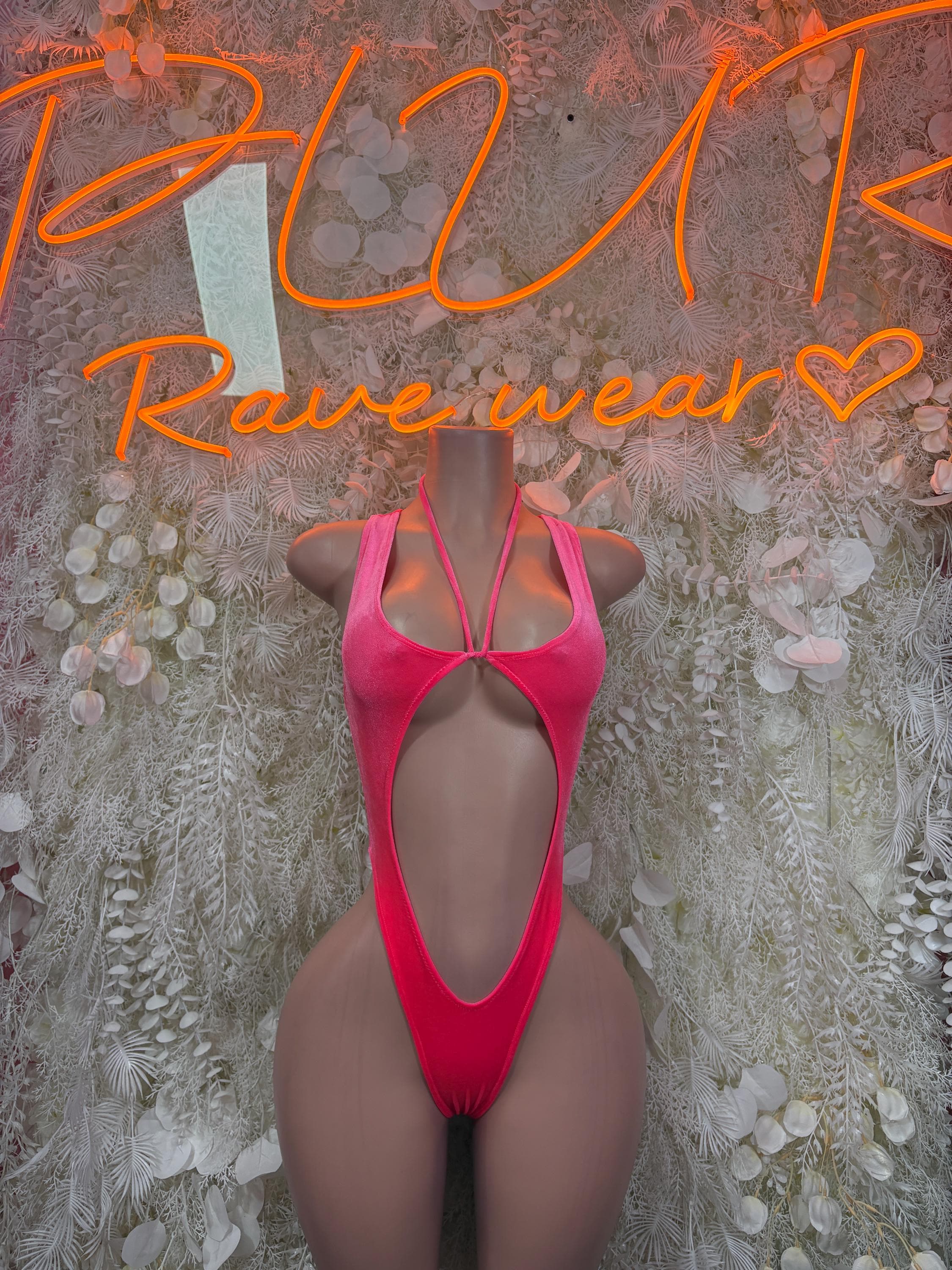 Pink velvet bodysuit with open back and narrow cross straps