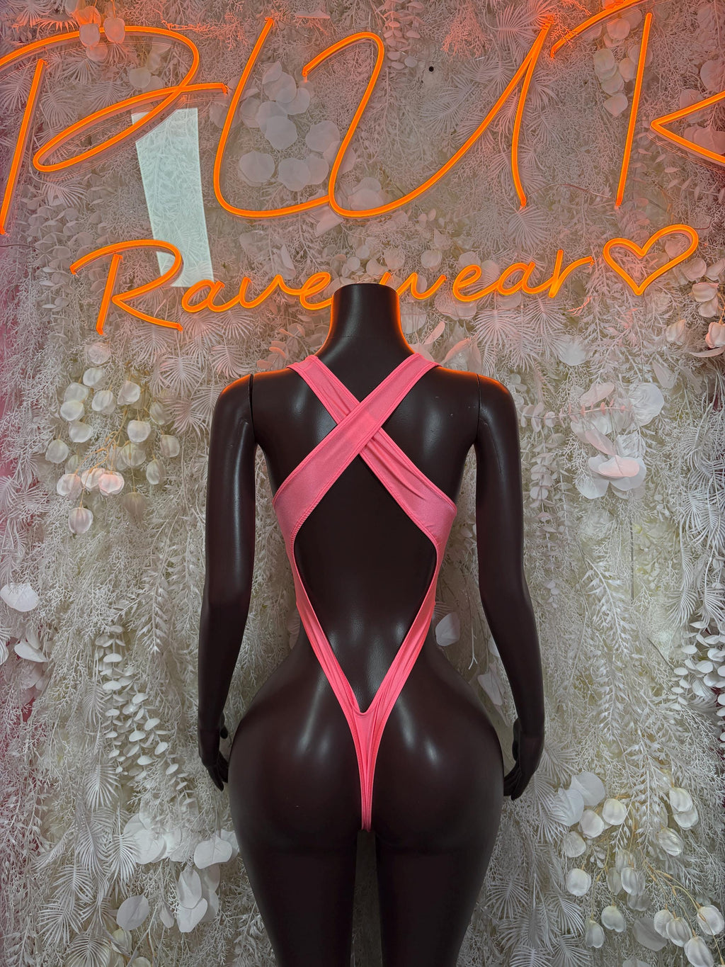 Pink festival bodysuit with crisscross back straps and high-cut bottom