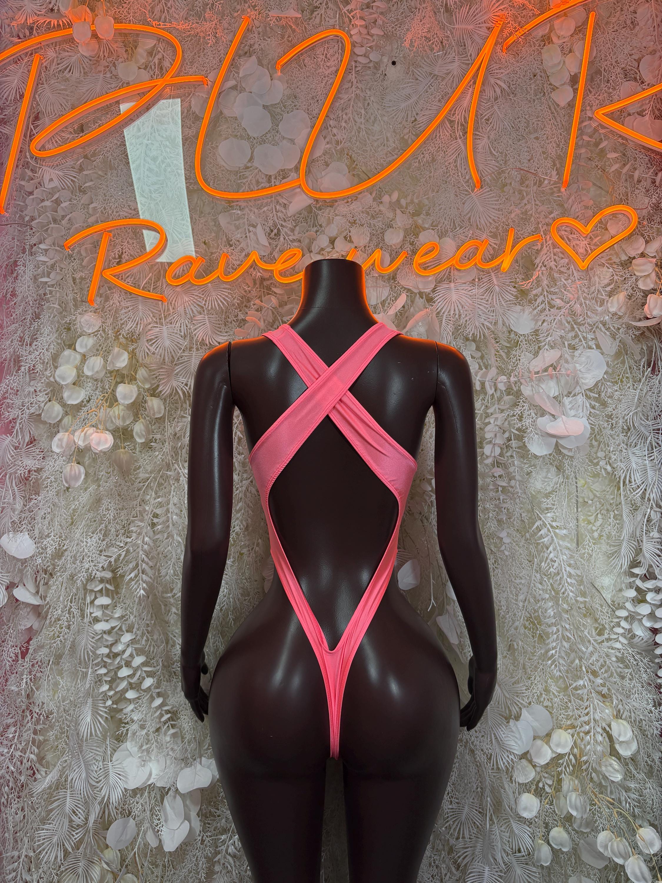 Pink festival bodysuit with crisscross back straps and high-cut bottom