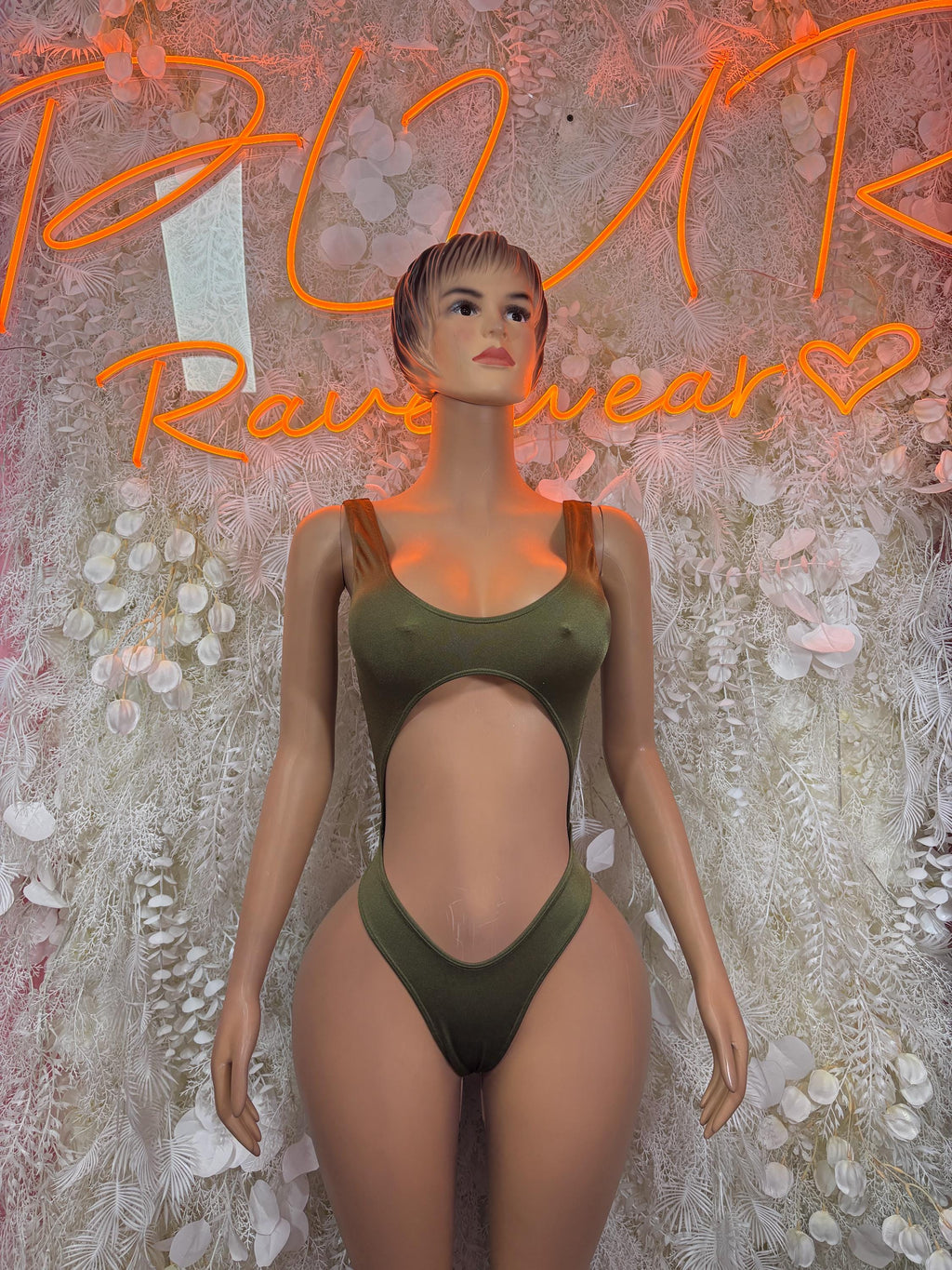 Green cutout bodysuit with halter straps and high-leg fit