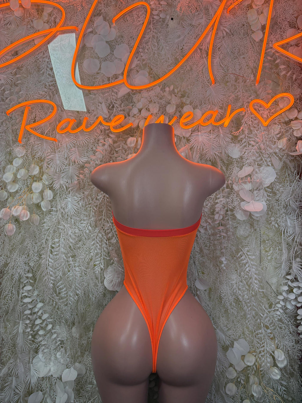 Orange backless halter bodysuit with narrow straps and deep V back