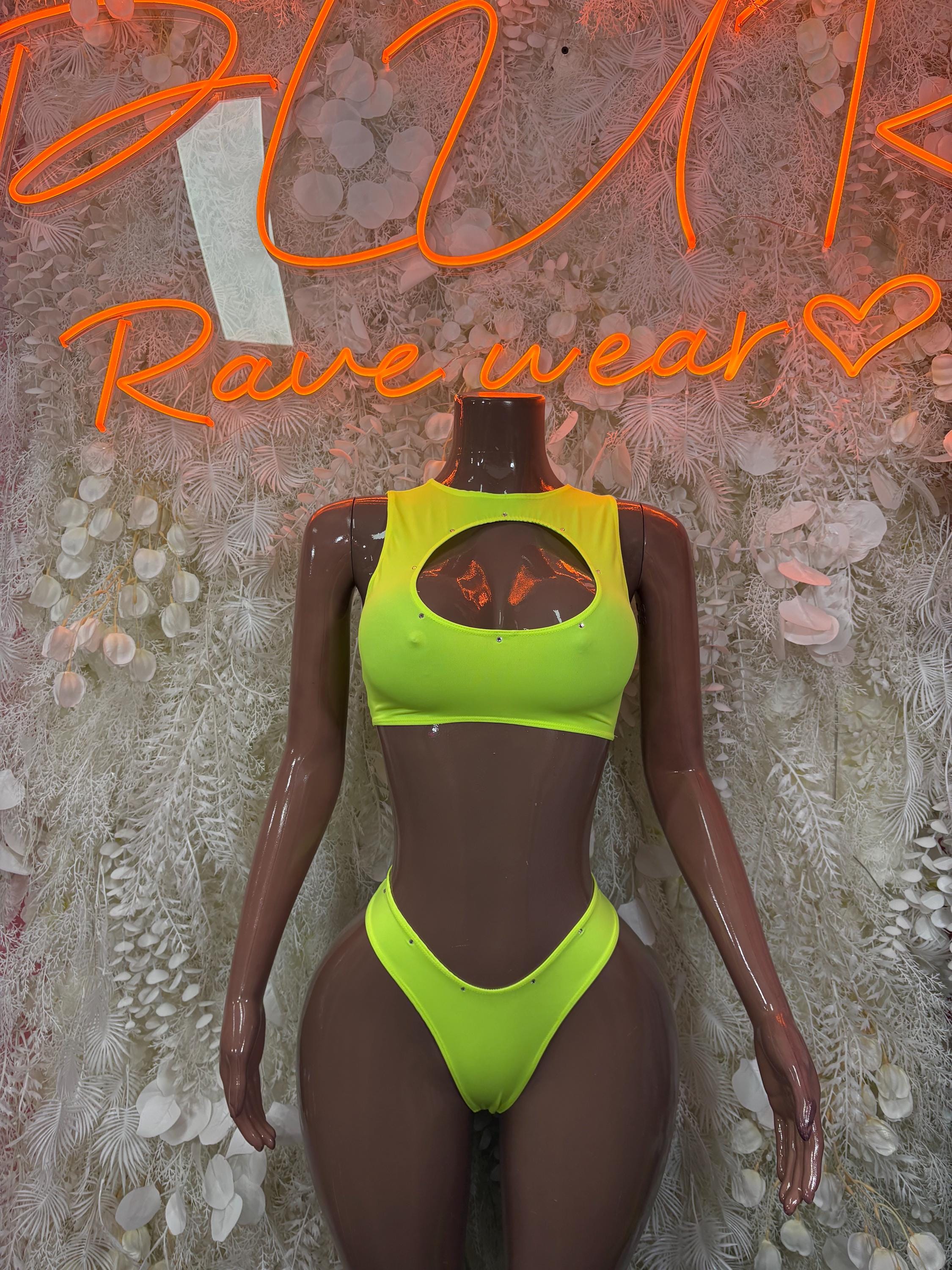 Neon green crop top with oval cutout and matching high-cut bikini bottoms on mannequin