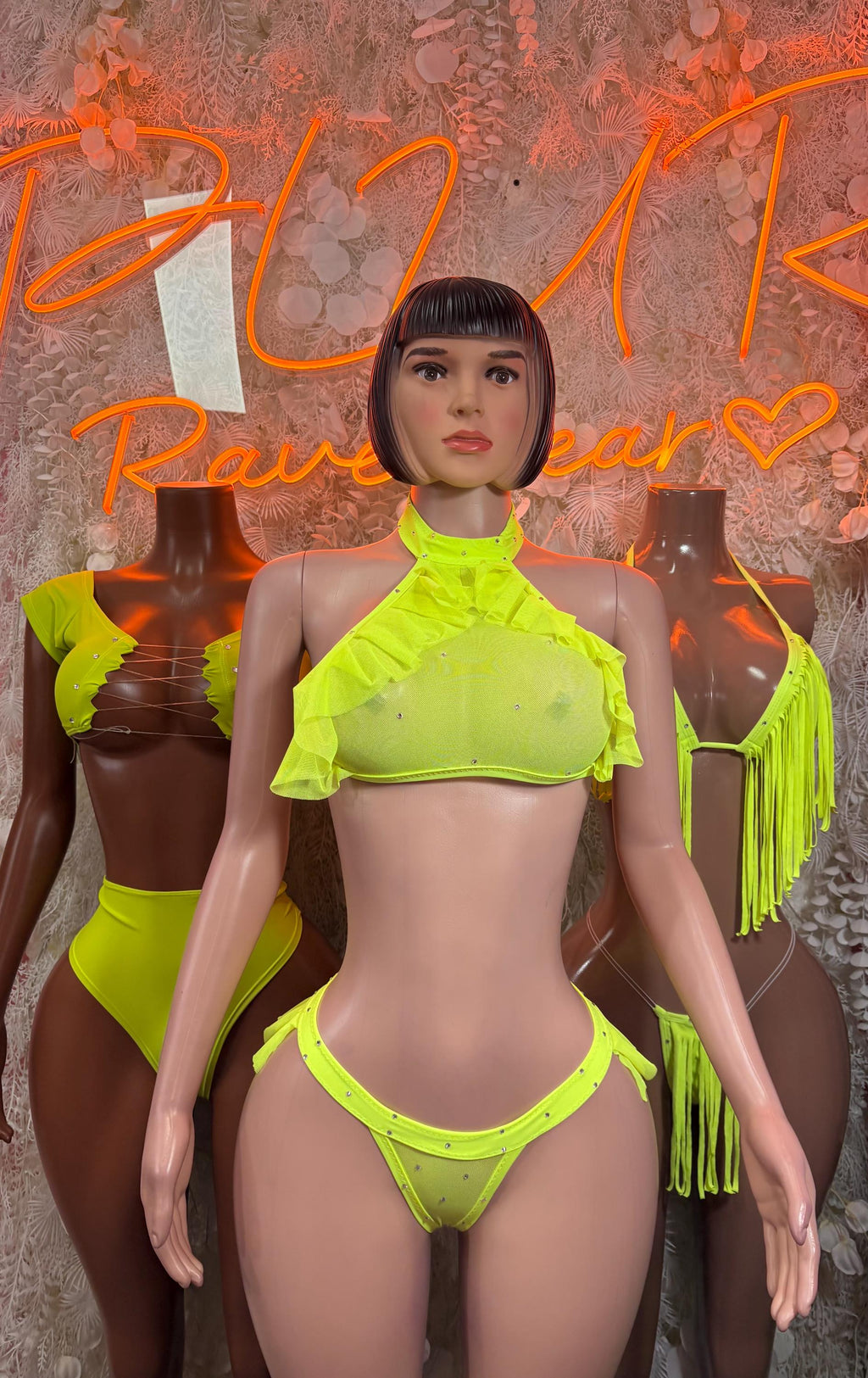 Neon green two-piece set with ruffled halter crop top, fringe trim, and matching bikini bottom