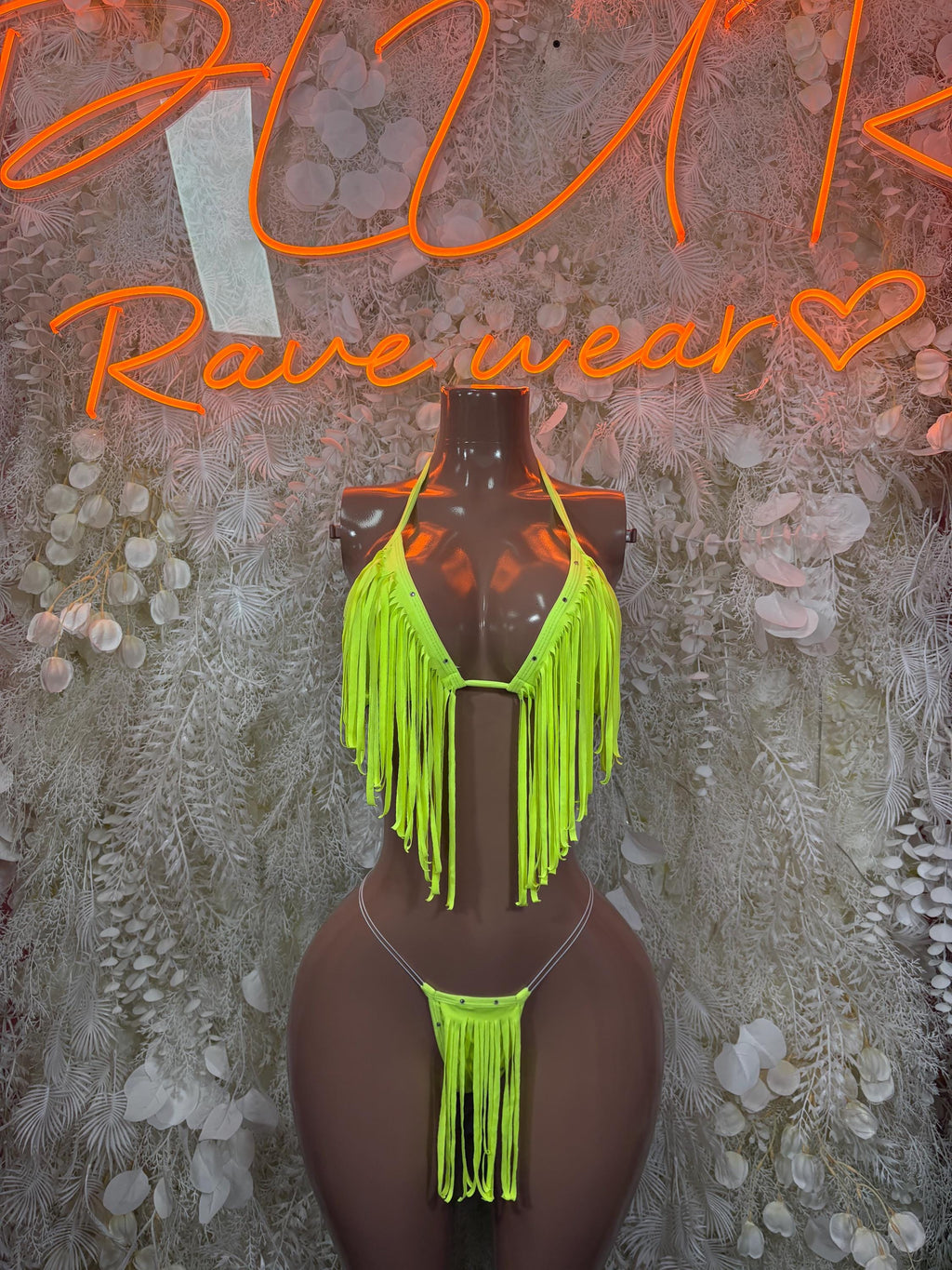 Neon green fringe two-piece set on mannequin, tie-back bralette and bikini bottoms