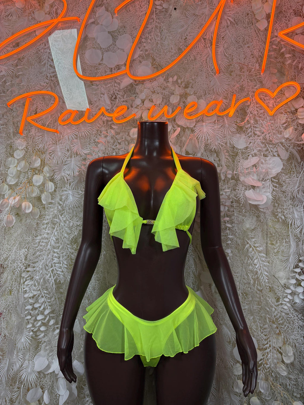 Neon green ruffle bikini set with layered triangle top and tiered skirt bottom.