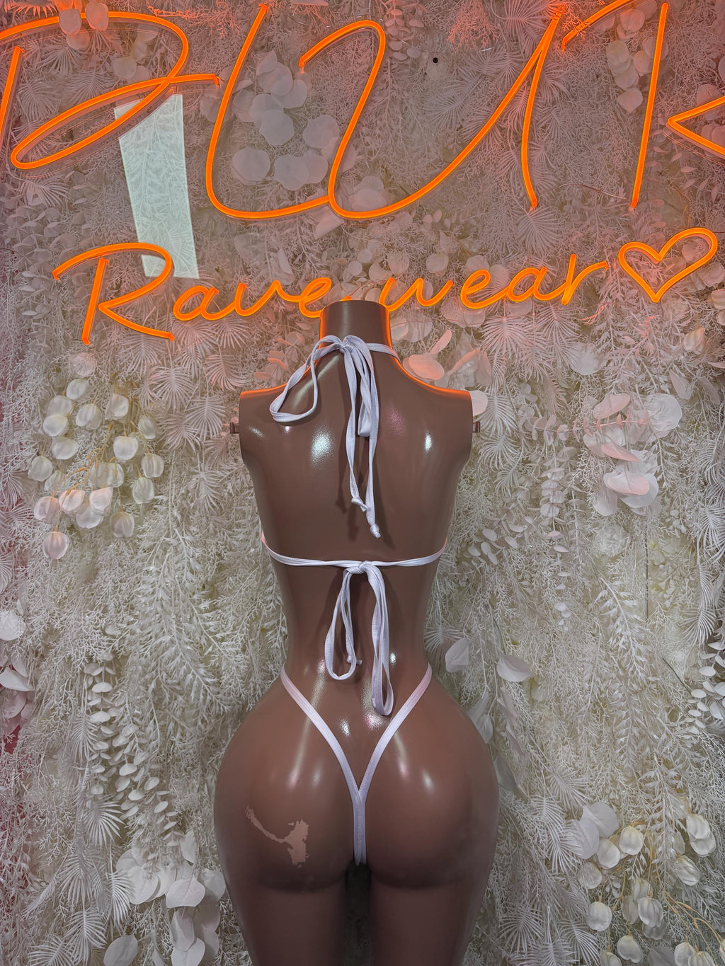 White string bodysuit with back tie, strappy sides, and thong cutout