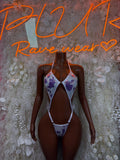 One-piece cow print bodysuit in purple and white, deep V front with halter straps