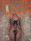 Cow print one-piece bodysuit with black lace-up front and cheeky cut