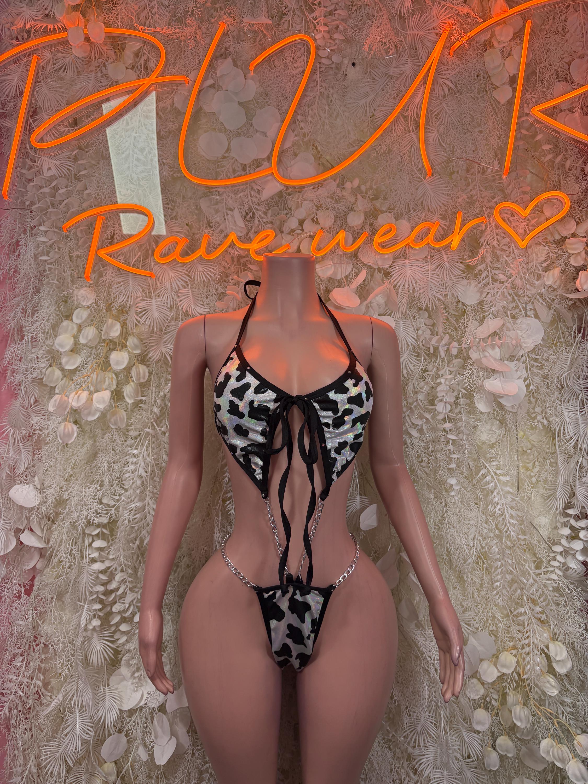 Cow print one-piece bodysuit with black lace-up front and cheeky cut