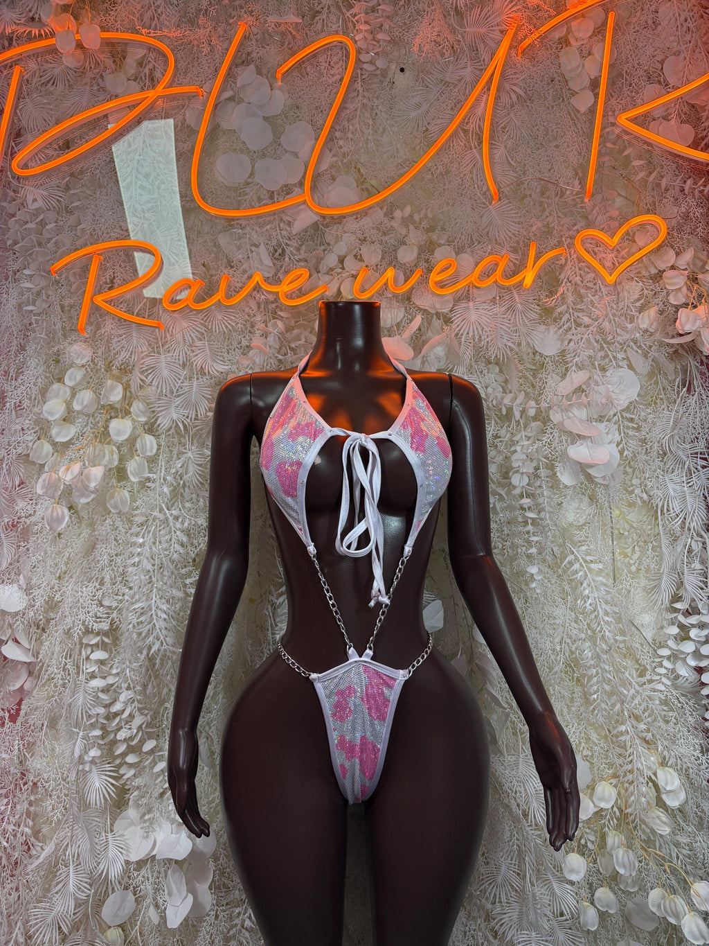 Cow-print one-piece bodysuit with halter tie and thong cut, pink and white accents