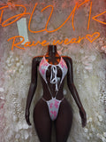 Cow-print one-piece bodysuit with halter tie and thong cut, pink and white accents