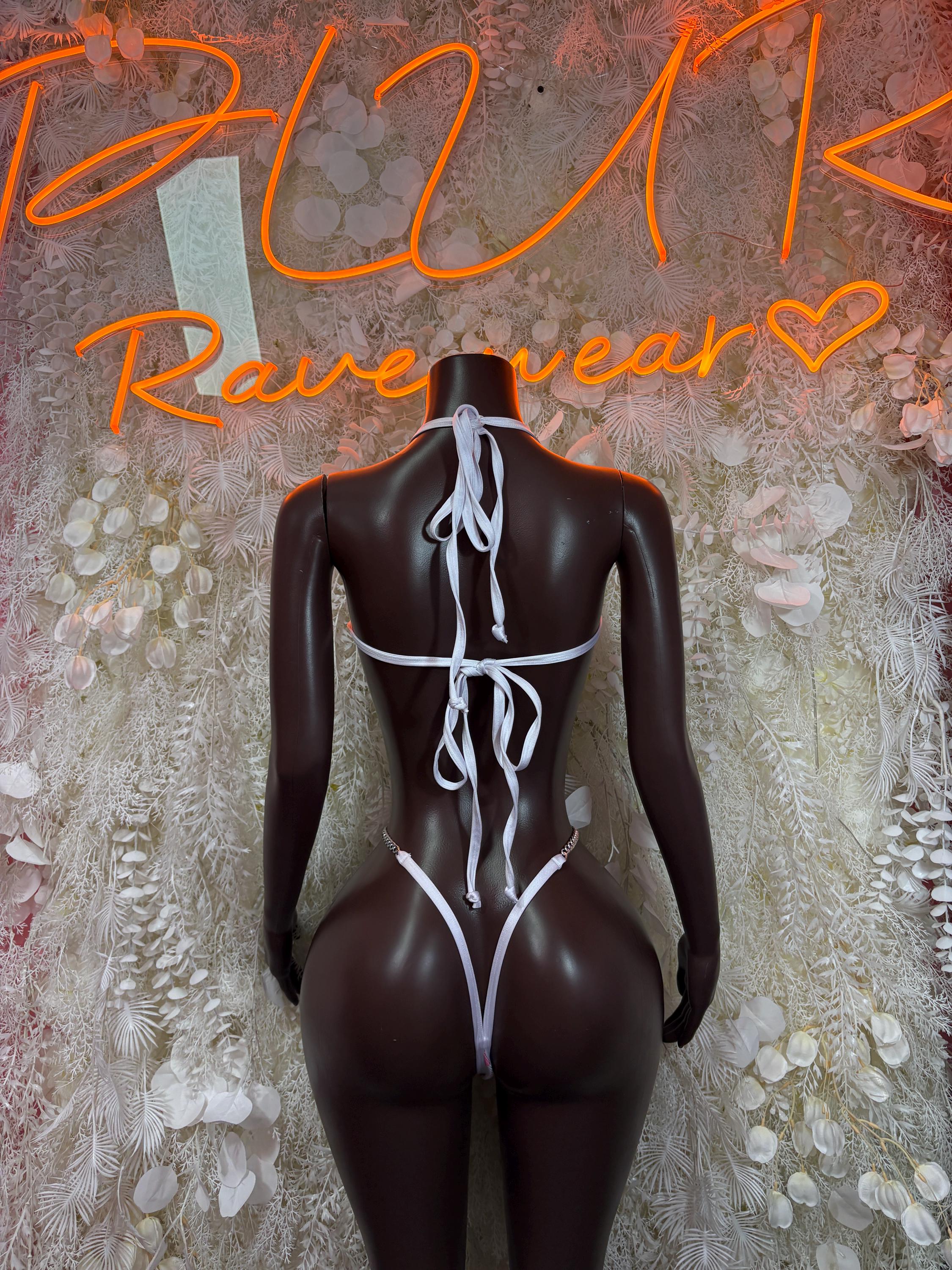 Cow-print one-piece bodysuit back view with crisscross lace-up straps and thong cut