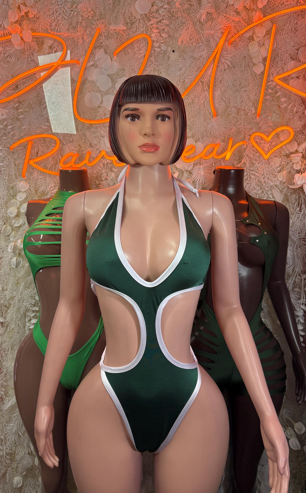 Green halter bodysuit with white-trim cutout panels and open V front