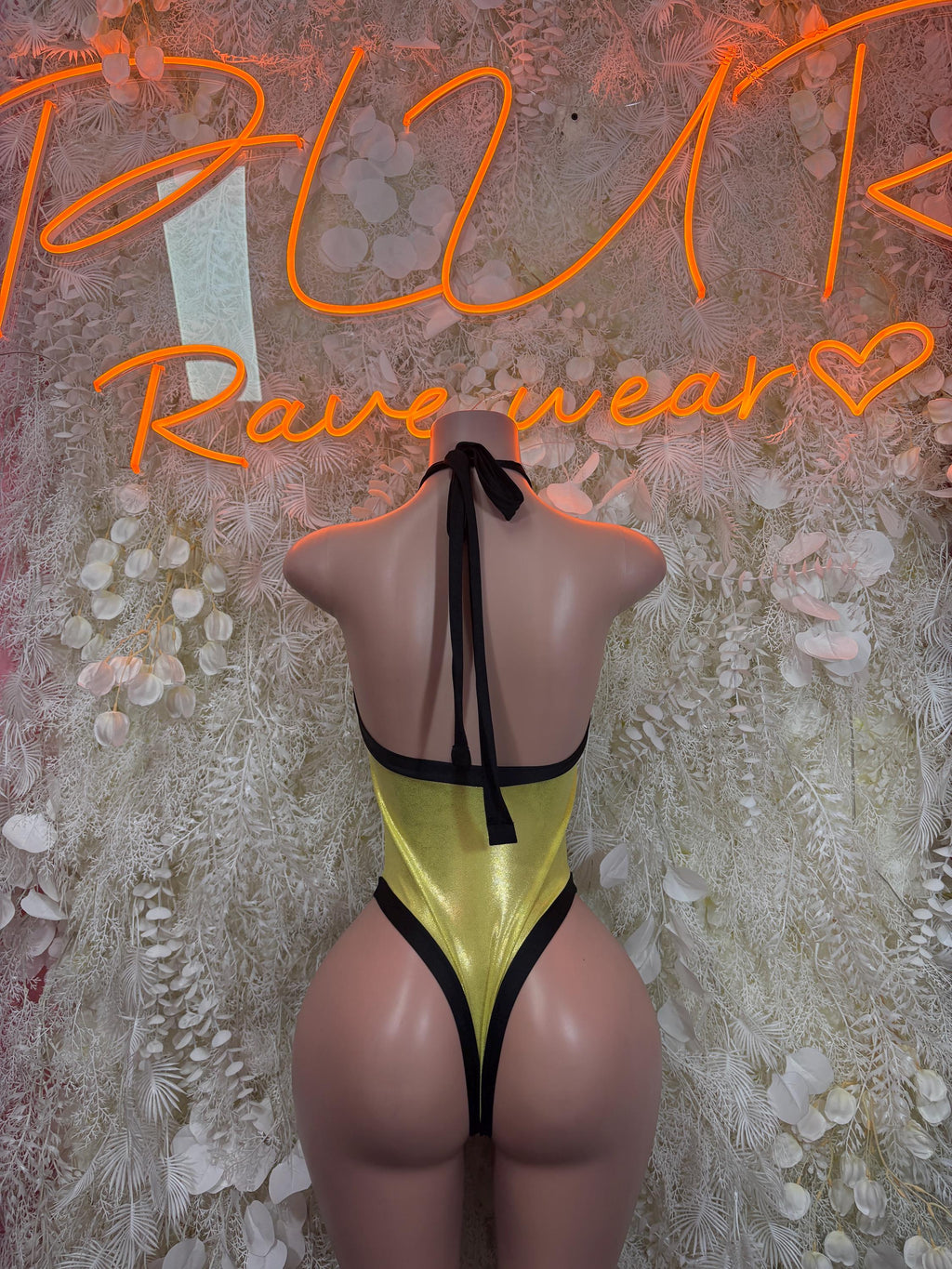 Yellow metallic bodysuit with black trim and open back, tied halter strap